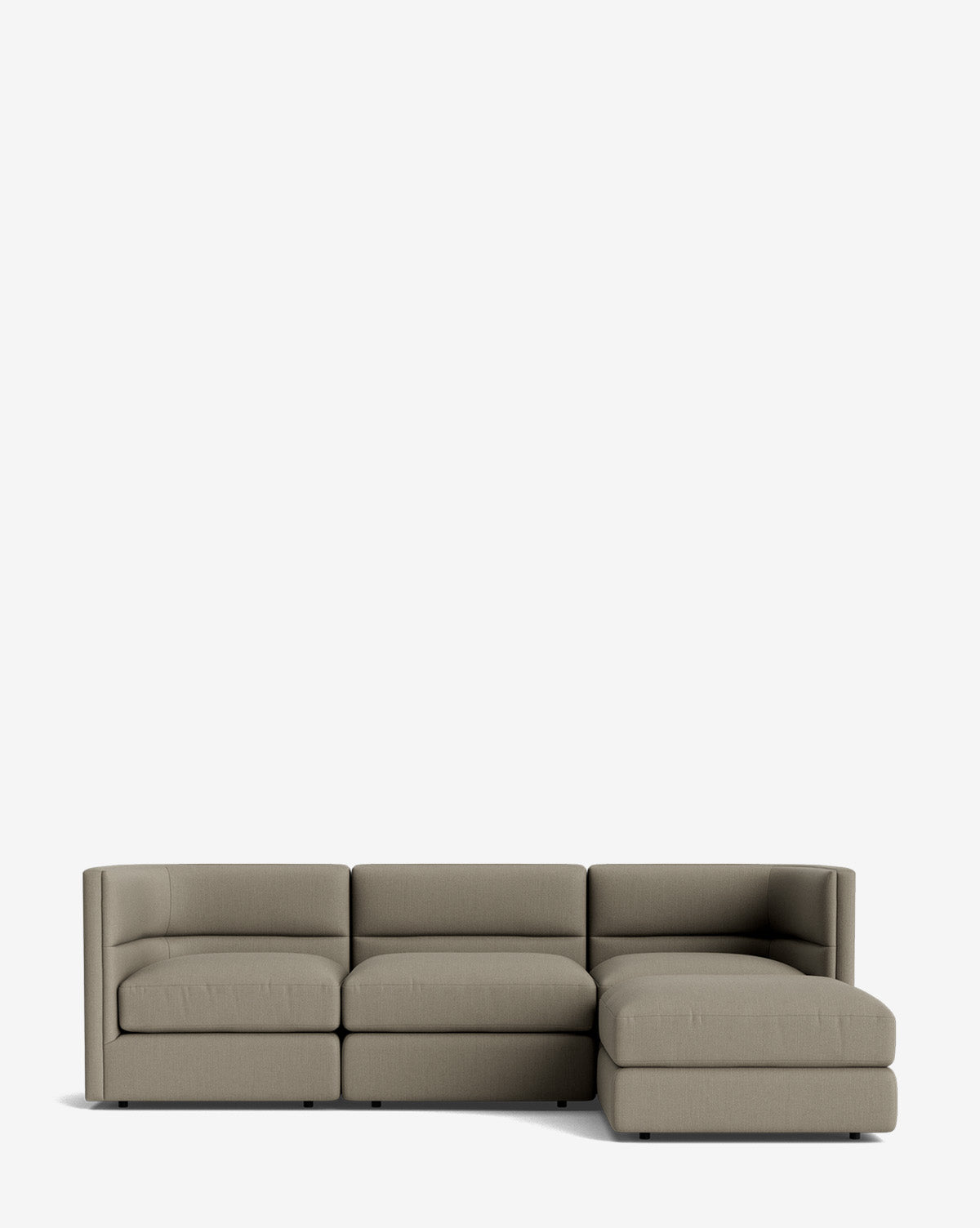 The Claremont Modular Sofa with Ottoman 99 is a modern, light gray three-seater with a right-side chaise and channeled back, shown on a plain white background by McGee & Co.