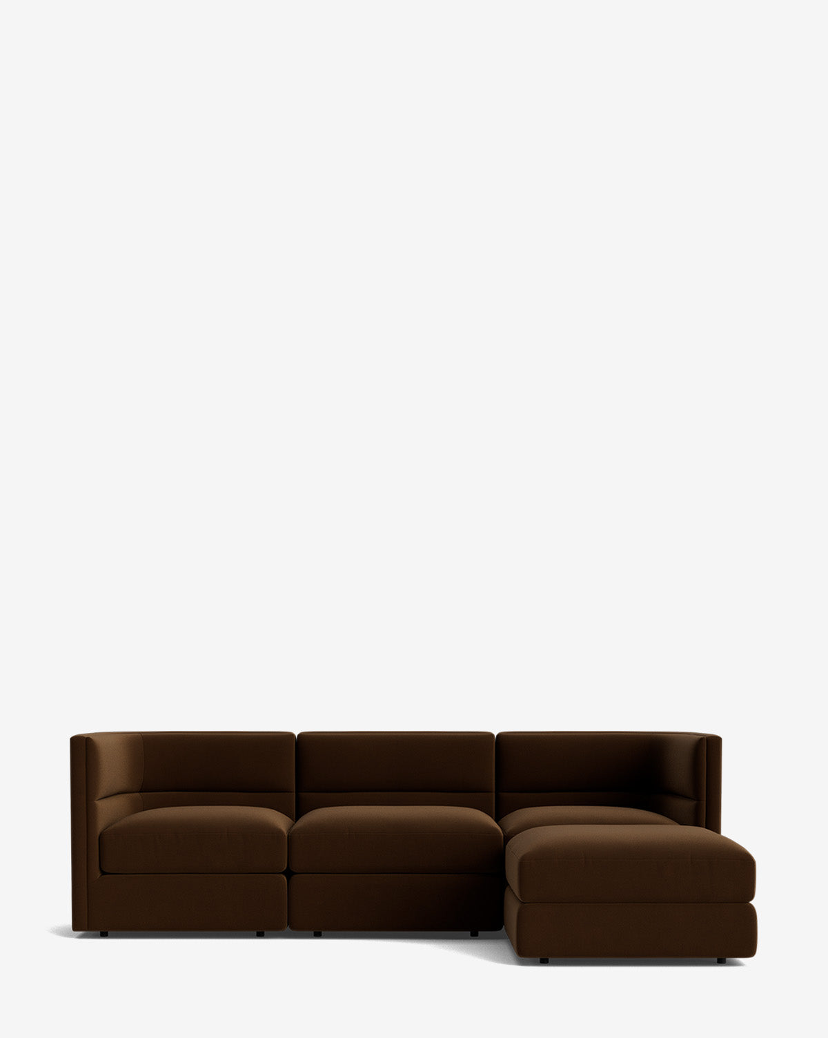 The Claremont Modular Sofa with Ottoman 99 is a modern dark brown sofa with a channeled back, three seats, and a right-side chaise lounge, shown against a plain white background by McGee & Co.