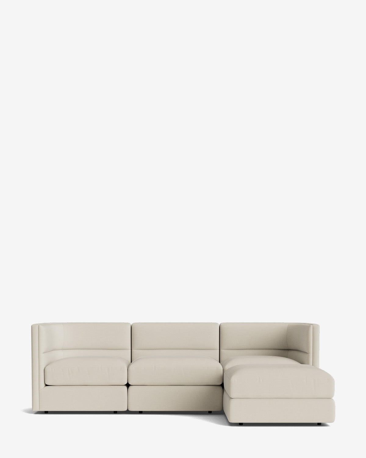 The Claremont Modular Sofa with Ottoman 99 is a modern, light beige three-seater with a channeled back and right-side chaise lounge, shown against a plain white background by McGee & Co.