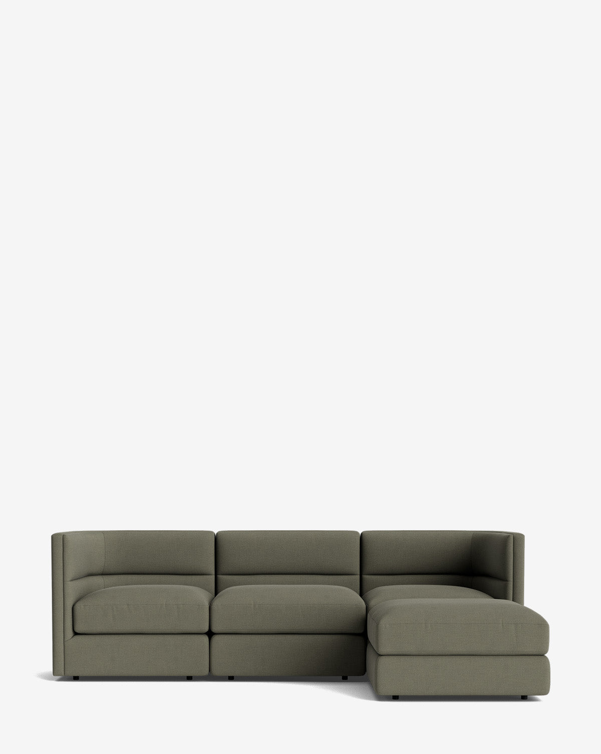 The Claremont Modular Sofa with Ottoman 99 in olive green features three seats, a right-side chaise lounge, clean lines, low arms, a channeled back, and a modern minimalist design set against a plain white background, by McGee & Co.