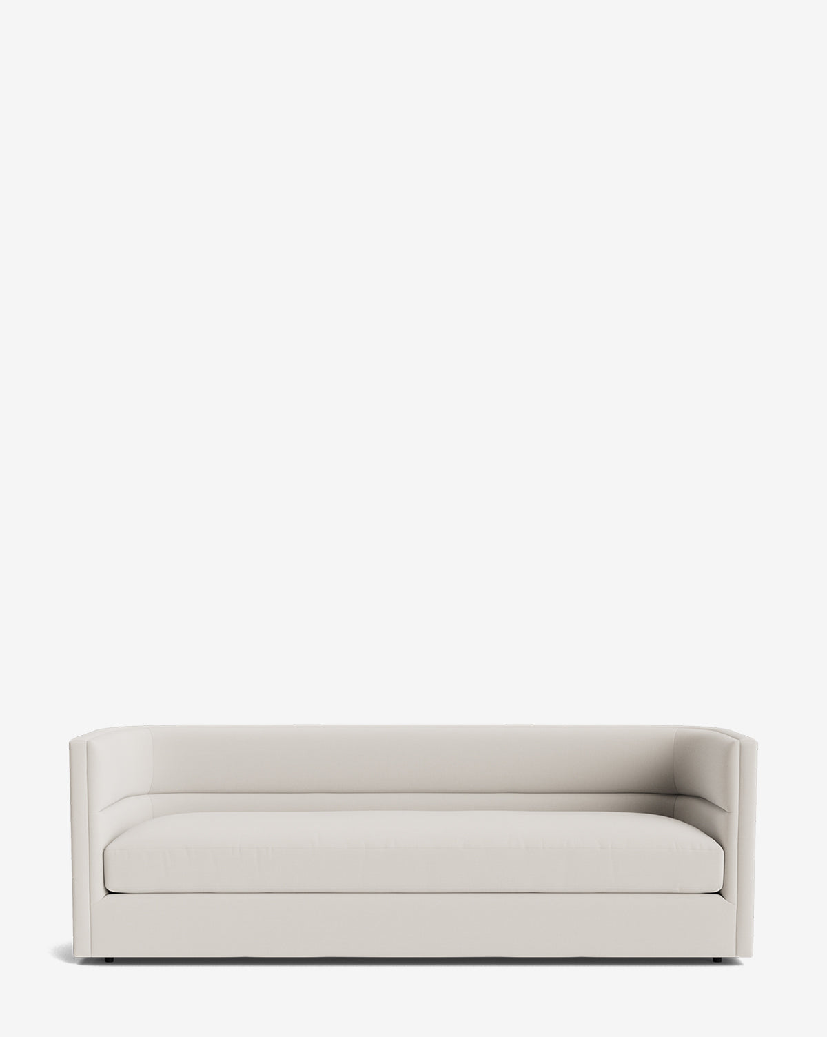 The Claremont Sofa 84 is a modern, minimalist piece in light gray fabric with straight lines, low arms, and a single seat cushion, displayed against a plain white background by McGee & Co.