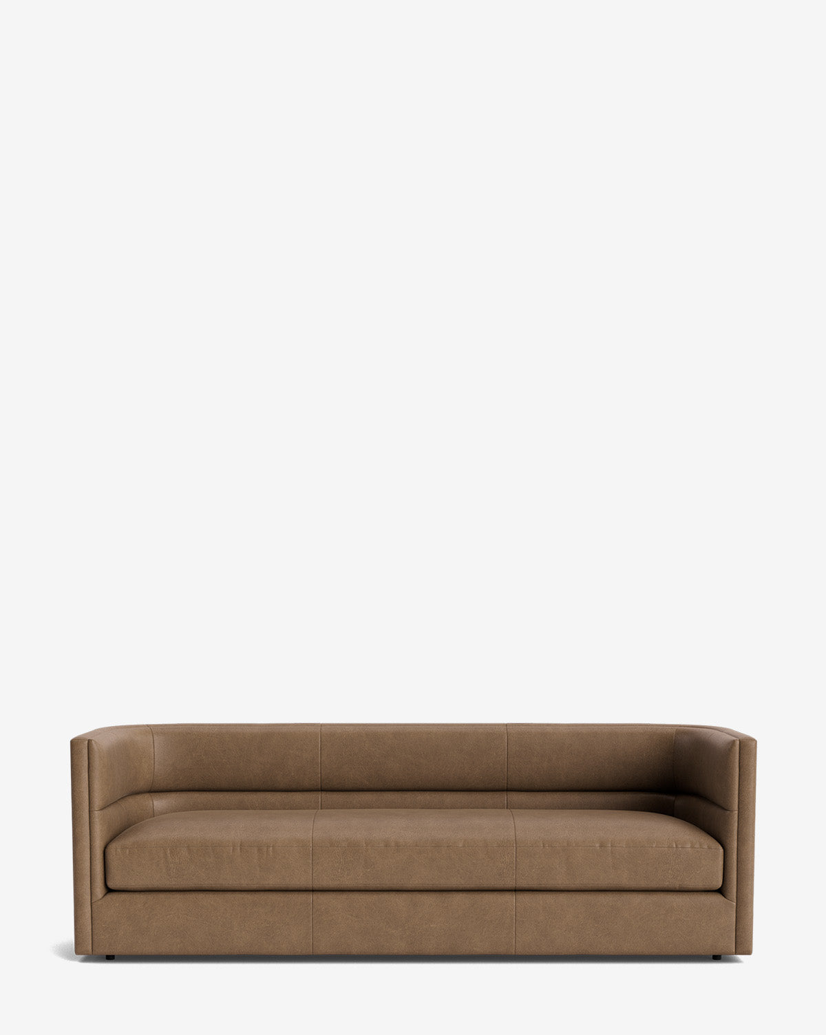 The Claremont Sofa 84 is a minimalist brown leather sofa with low, straight arms and a boxy design, set against a plain white background for a vintage-inspired look by McGee & Co.