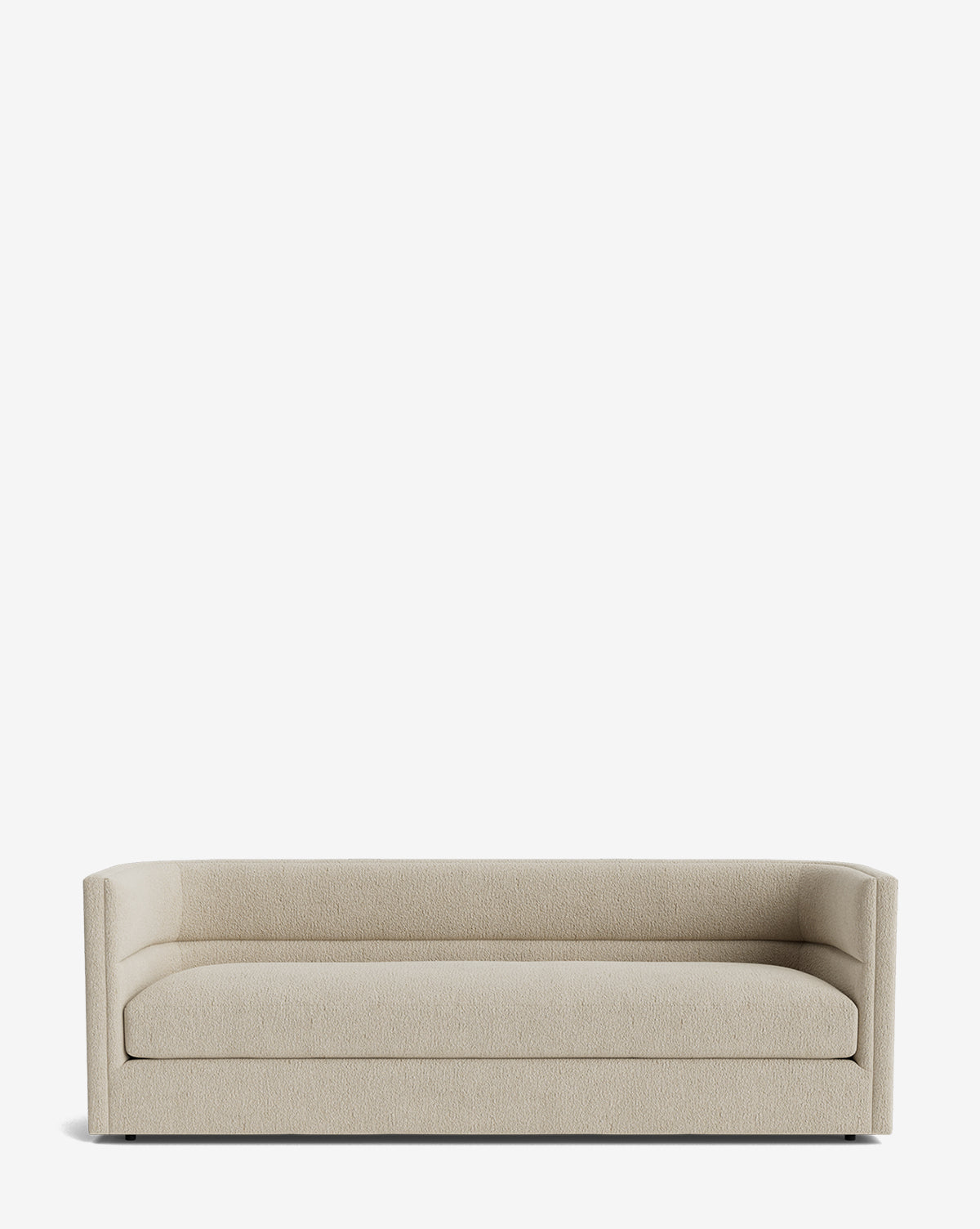 The Claremont Sofa 84 features a modern, light beige upholstery in high-quality fabric. Its minimalist, boxy design with low squared arms offers vintage-inspired style, comfort, and ample seating for your space, by McGee & Co.