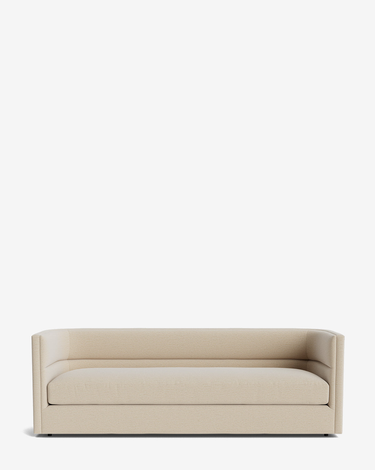 The Claremont Sofa 84 is a modern, minimalist beige sofa with low arms and backrest, upholstered in high-quality textured fabric, shown against a plain white background by McGee & Co.