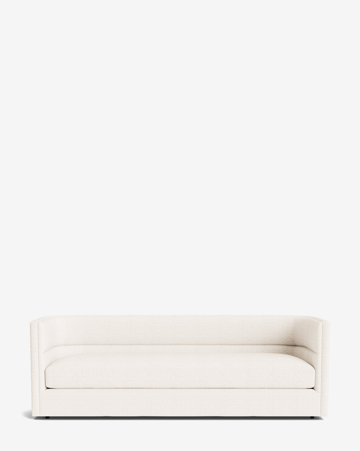 The Claremont Sofa 84 is a modern, minimalist piece in cream high-quality fabric, featuring low arms and a straight backrest, displayed against a plain white background by McGee & Co.
