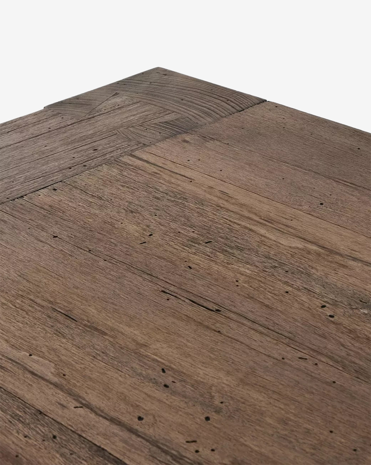 Close-up of the Clellan Dining Tables corner, showcasing its modern design with a natural, rustic finish that highlights the oak veneer’s grain patterns, subtle color variations, and small imperfections, by McGee & Co.