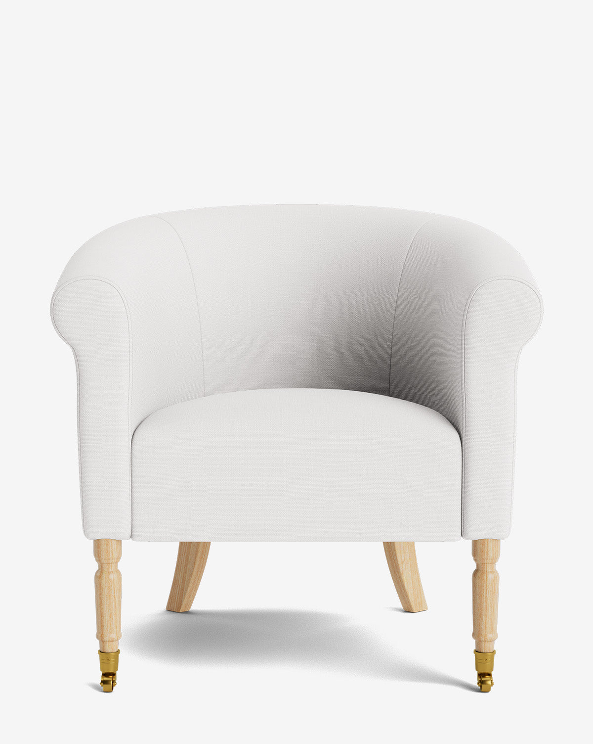 The Clemence Lounge Chair features modern white upholstery, curved arms, light wooden legs, and brass castors on the front legs, shown against a plain white background, by McGee & Co.