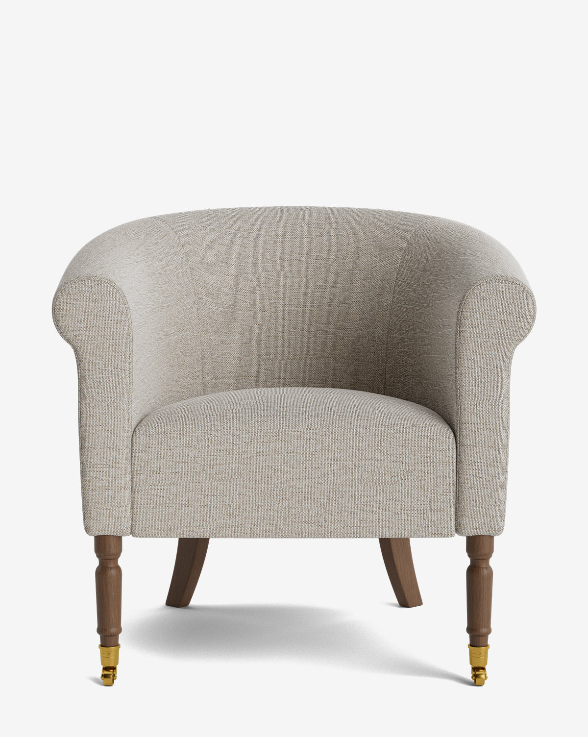 The Clemence Lounge Chair features beige designer fabric upholstery, rounded arms, wooden legs with brass castors on the front, and is shown against a plain white background by McGee & Co.