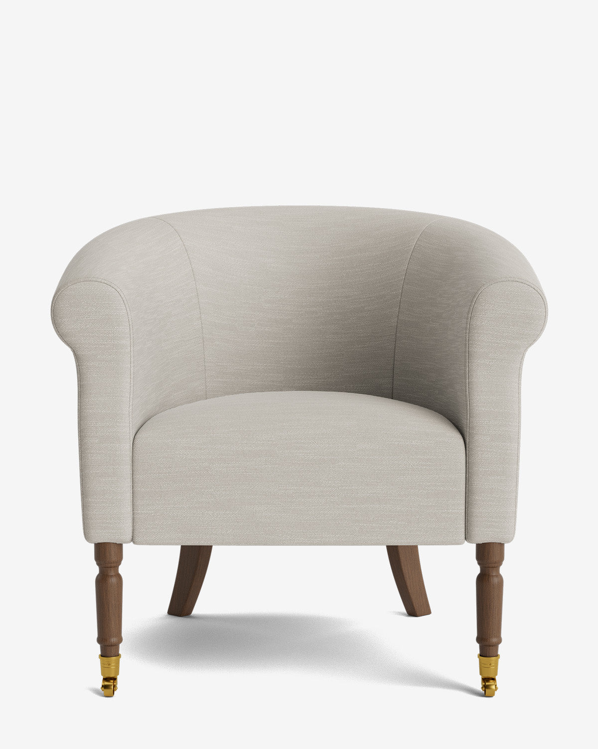 The Clemence Lounge Chair is a classic beige upholstered armchair with a rounded back, rolled arms, wooden legs, and brass castor wheels on the front legs, pictured against a plain white background by McGee & Co.