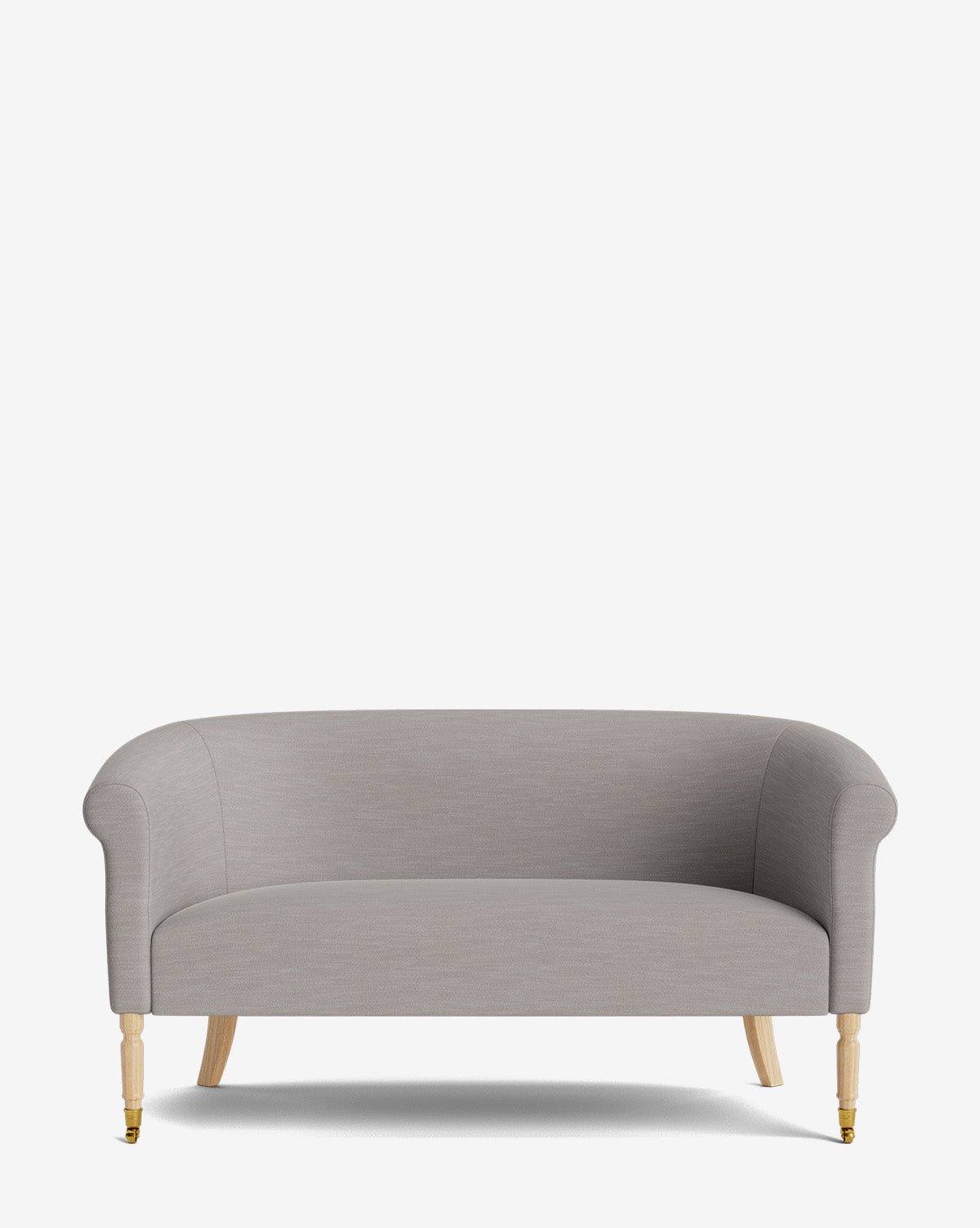 The Clemence Settee 60 features light gray designer fabric, rounded arms, and wooden legs—one front left leg with a brass caster—set against a plain white background. A chic addition to any stylish living space by McGee & Co.