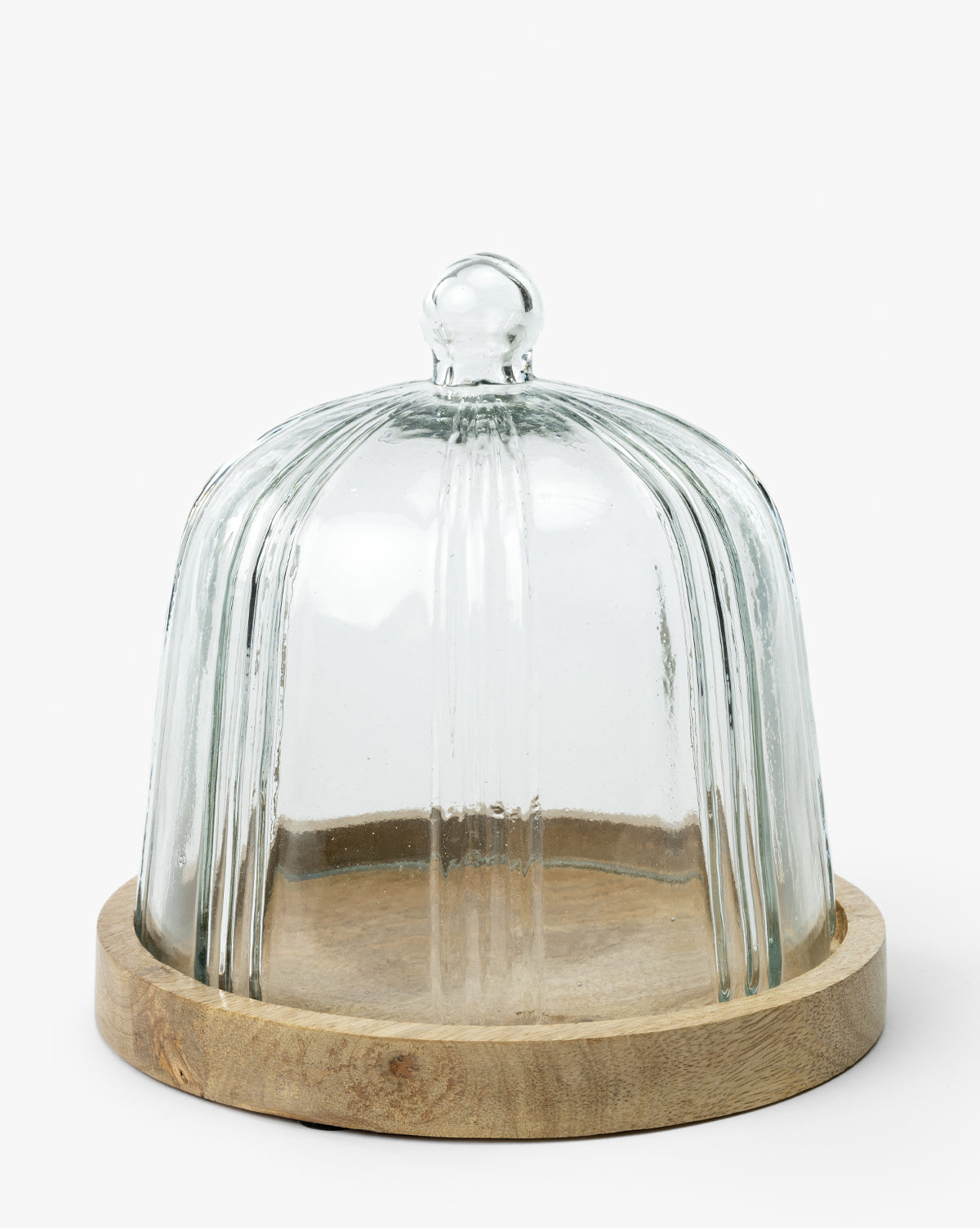 The Cloche with Recycled Glass features a clear ribbed dome with a round handle on a circular wooden base, creating a stylish kitchen display against a plain white background by McGee & Co.