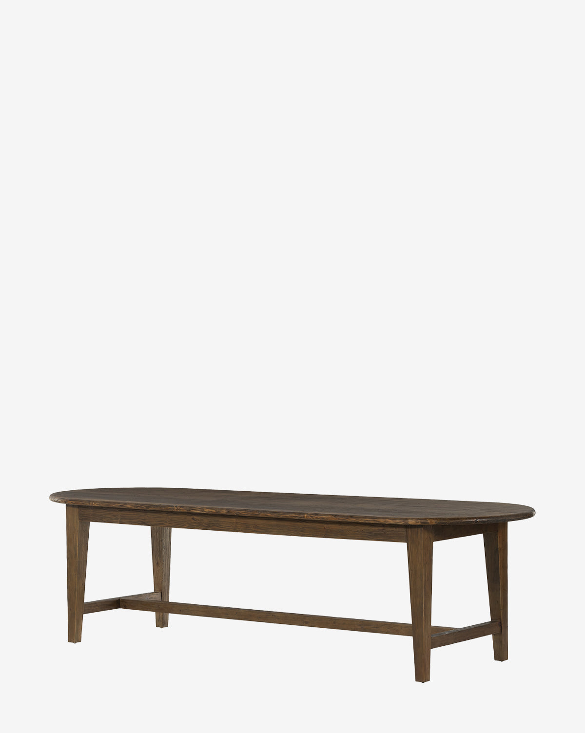 The Constance Dining Table showcases a long oval design made from solid pine in a dark brown finish with four angled legs, adding modern farmhouse charm to your dining space, by McGee & Co. Displayed against a plain white background.