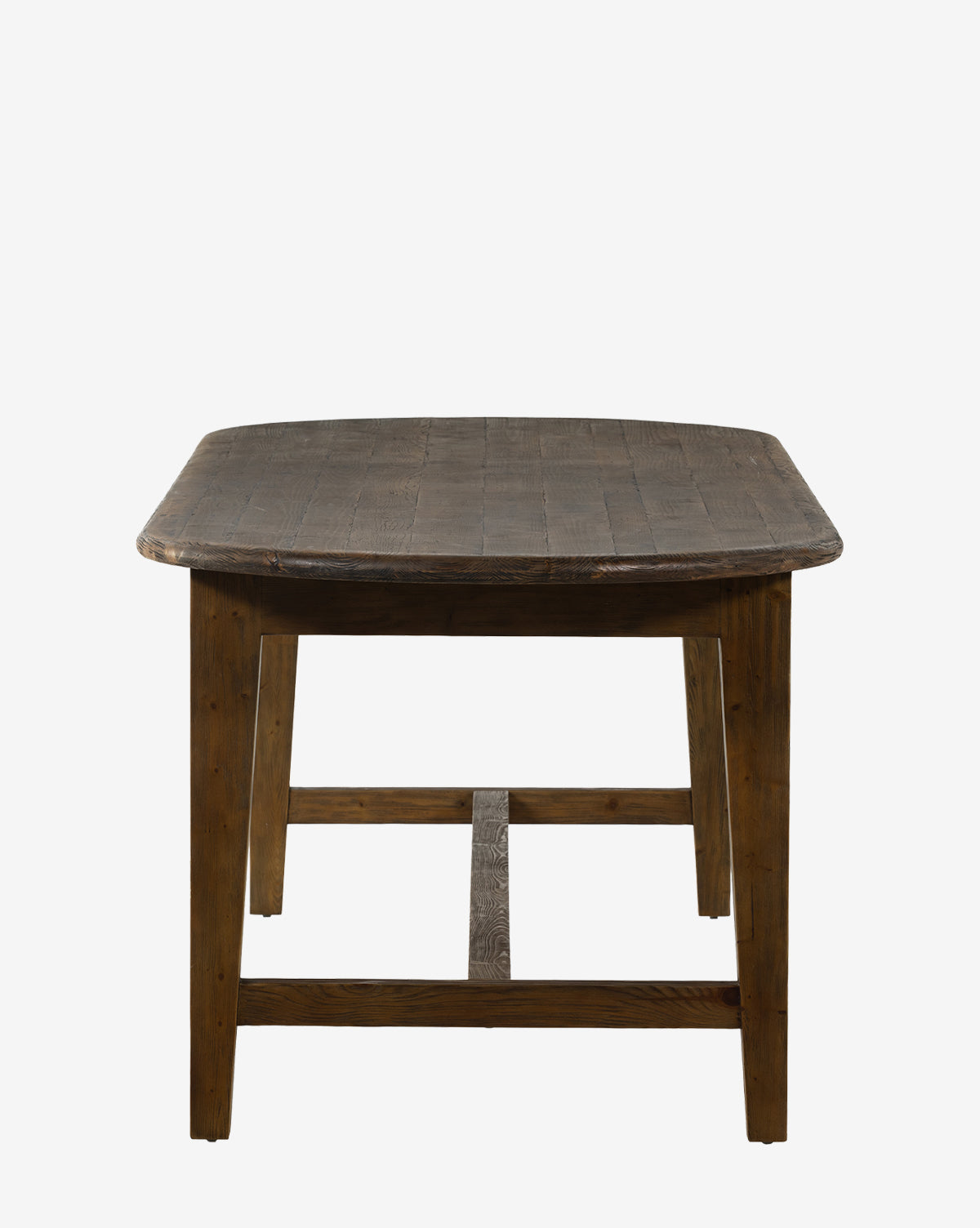 The Constance Dining Table features solid pine construction, a dark rustic finish, sturdy legs, and a rectangular shape. Its slightly textured surface adds charm, making it ideal for modern farmhouse interiors against white backdrops by McGee & Co.