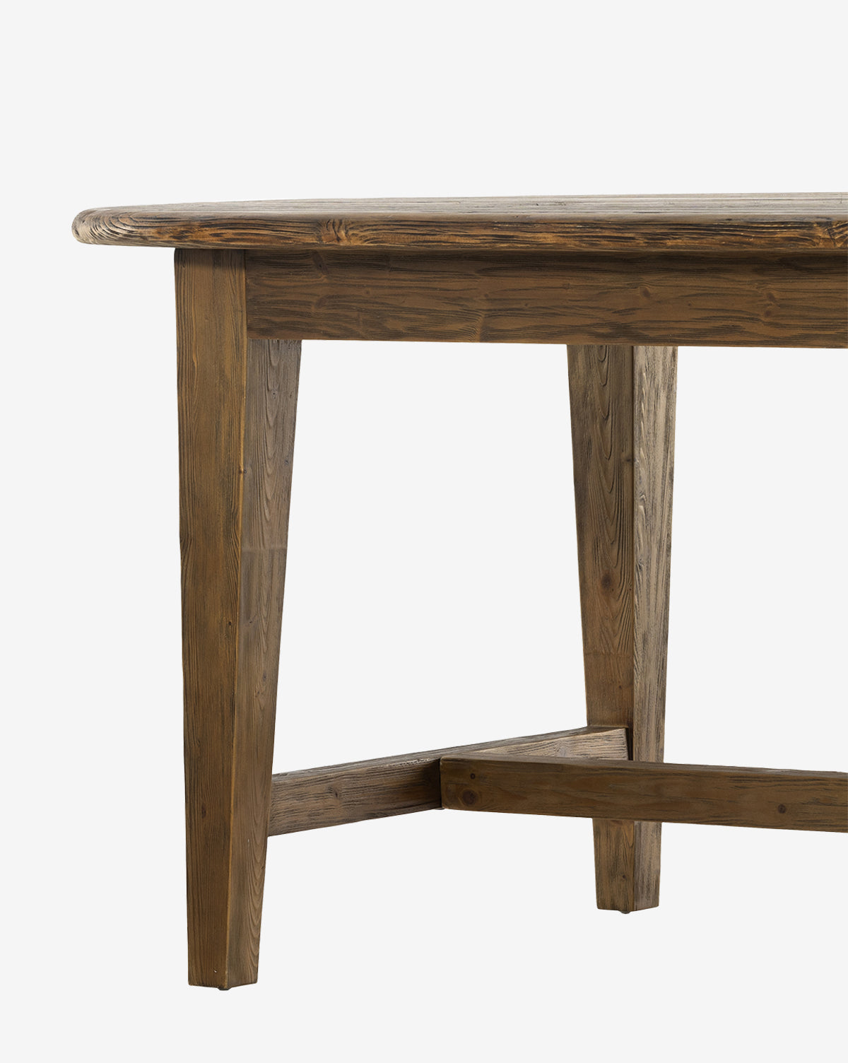A close-up of the Constance Dining Table highlights its modern farmhouse charm, featuring solid pine construction with angled legs and a crossbar support, set against a plain white background by McGee & Co.