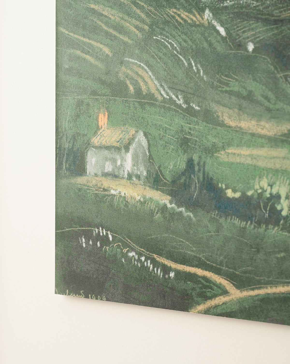 Country Dusk is a textured, impressionistic painting of a small house with a yellow roof and two orange chimneys among green hills and fields, presented in a black and gold frame, by McGee & Co.