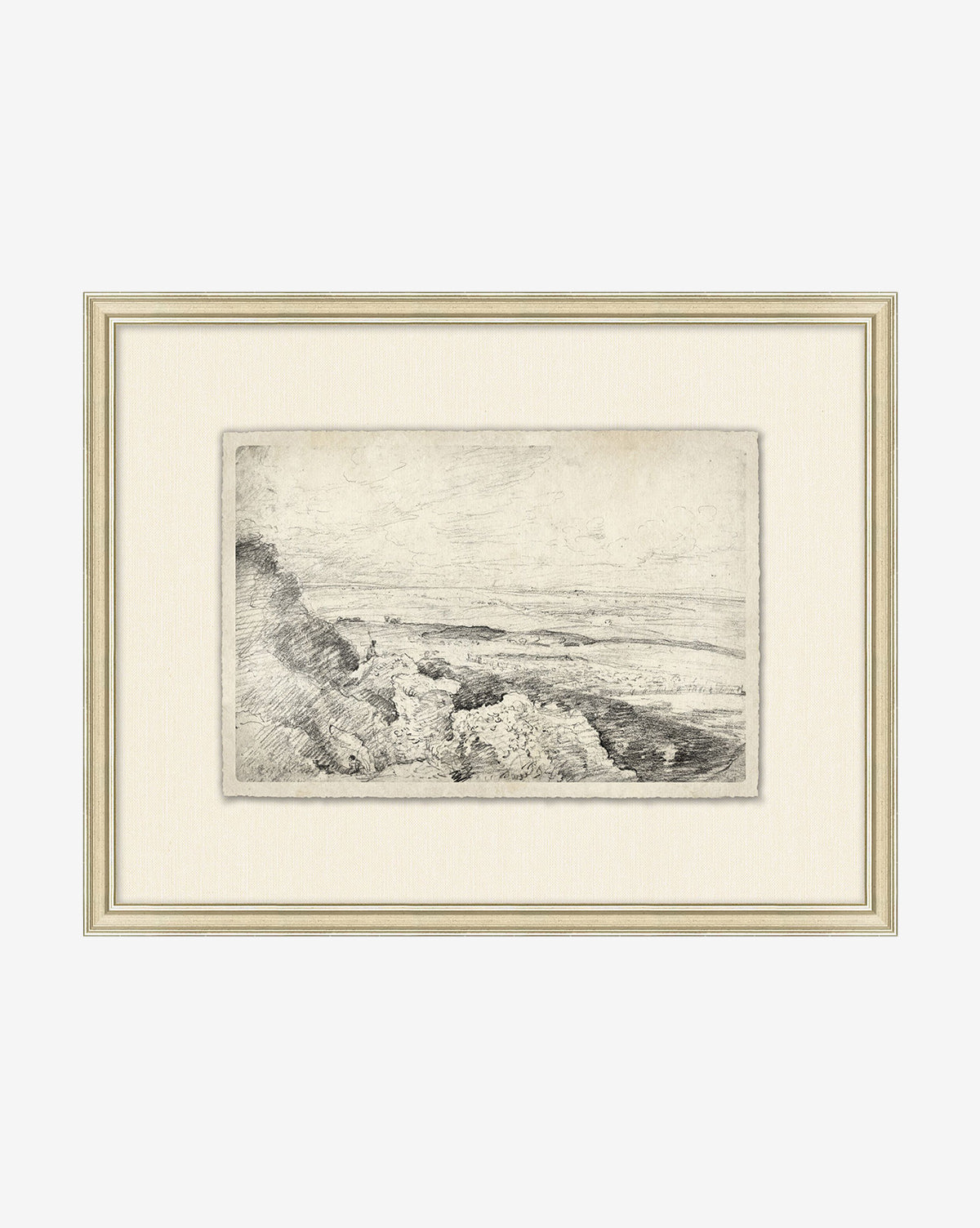 The Countryside Sketch features a framed black and white rocky coastal landscape with cliffs and sea, presented with a cream mat and light wooden frame for an elegant look.