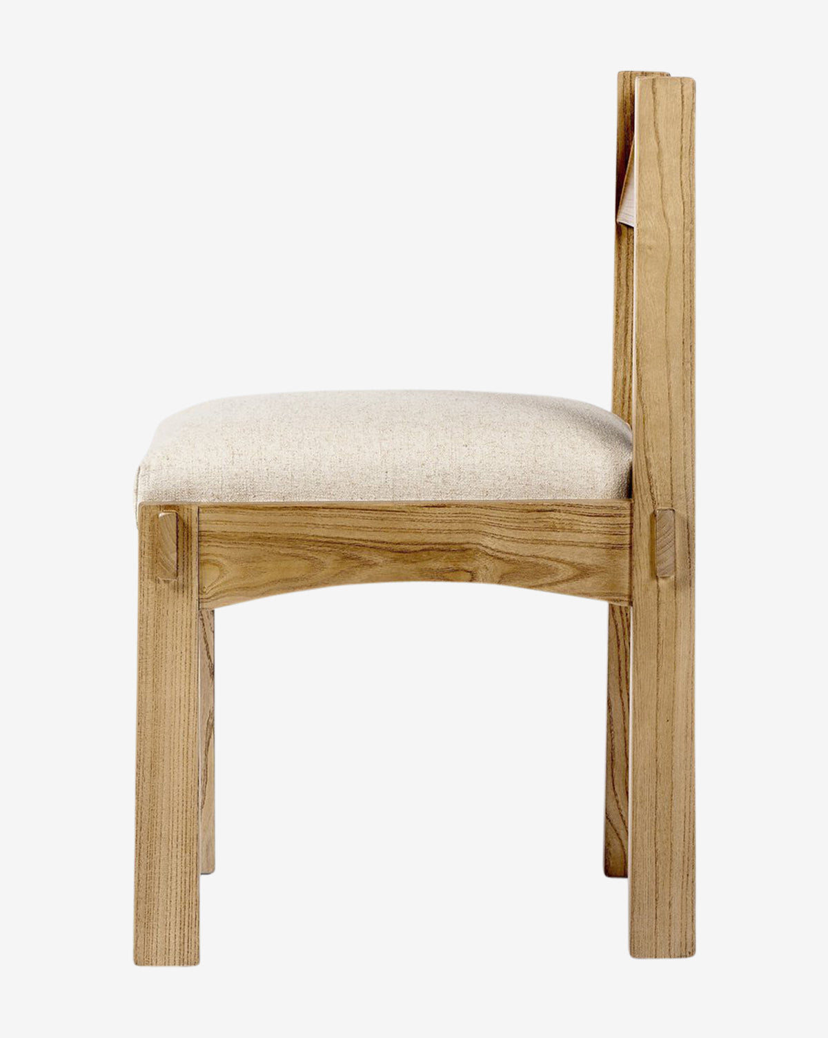 Side view of the Cyprian Dining Chair, showcasing its light beige performance fabric seat and clean, straight lines—an ideal choice to enhance any dining room—all set against a plain white background, by McGee & Co.