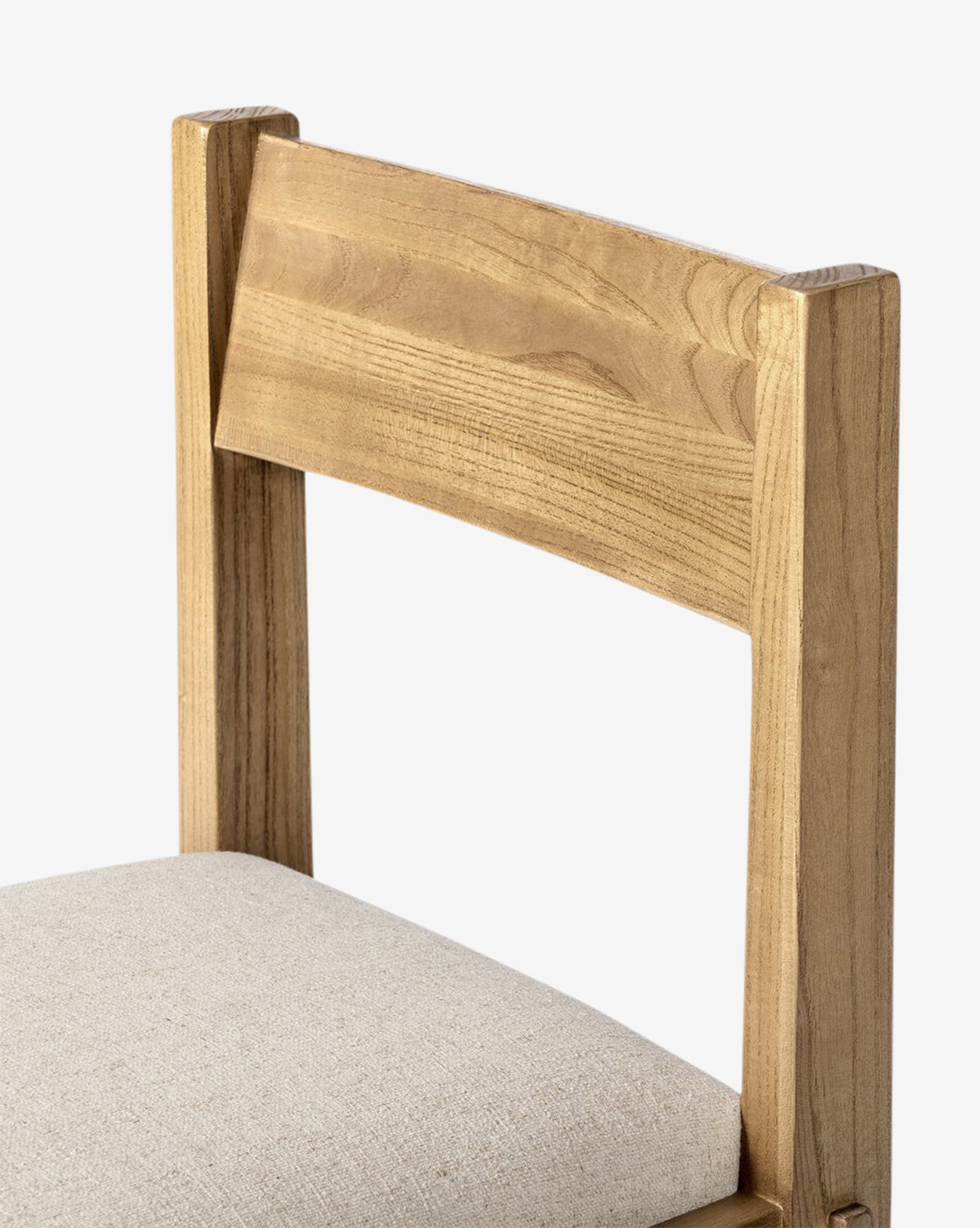 Close-up of the Cyprian Dining Chair, showcasing its light brown rectangular backrest and light beige performance fabric seat. This modern, simple design adds elegance to any dining room, by McGee & Co.