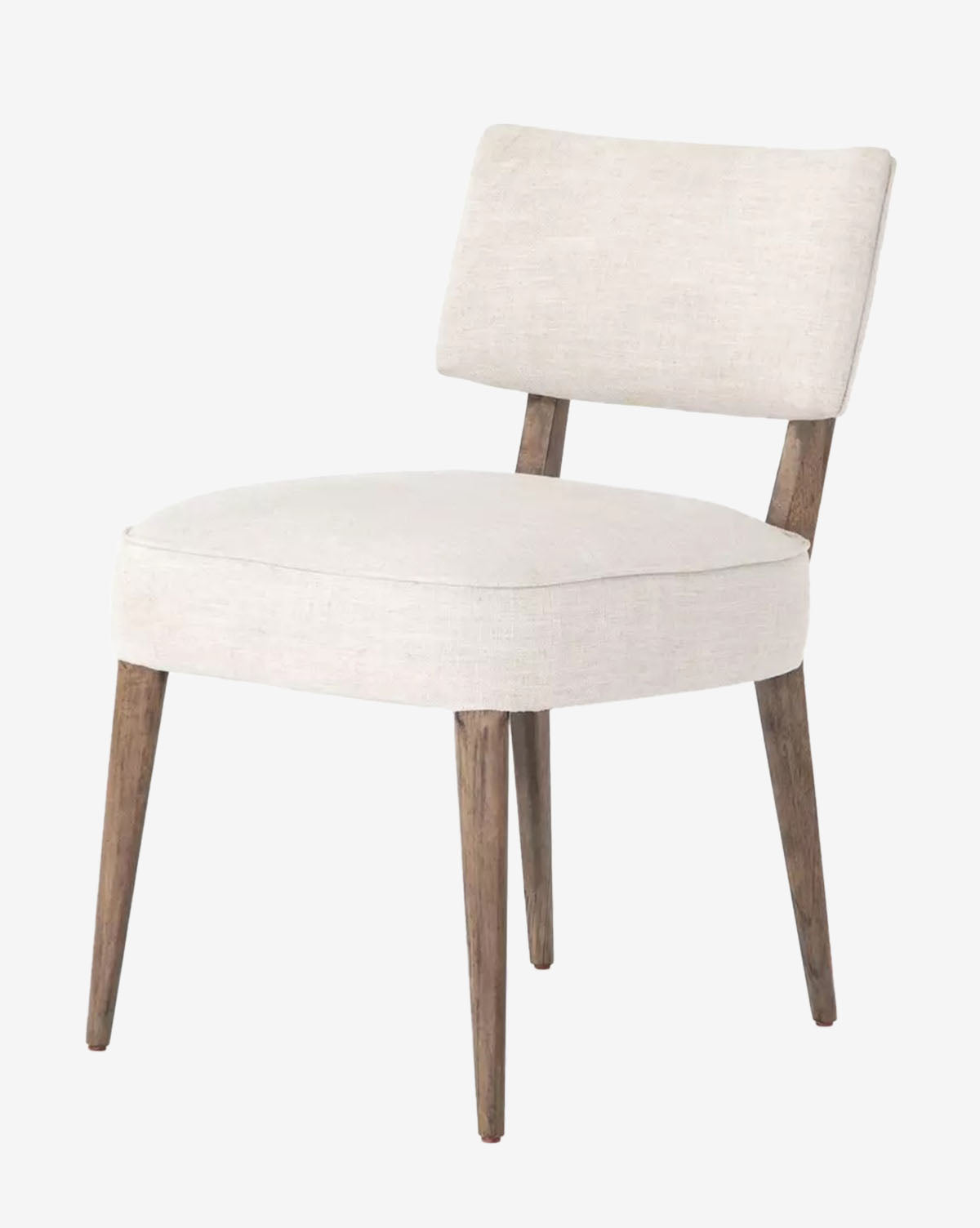 The Cyrene Dining Chair features a modern armless design with cushioned seat and back upholstered in ivory performance fabric, supported by four tapered wood legs in a natural finish, by McGee & Co.