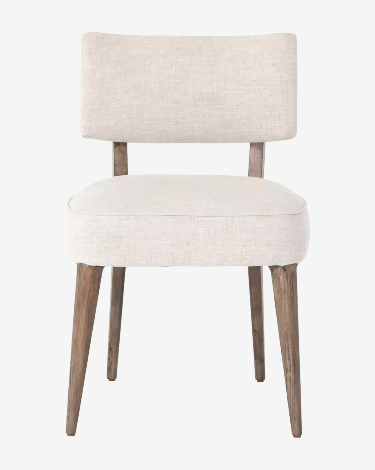 The Cyrene Dining Chair showcases a cushioned ivory performance fabric seat and backrest, supported by four angled light brown wood legs, all set against a plain white background, by McGee & Co.