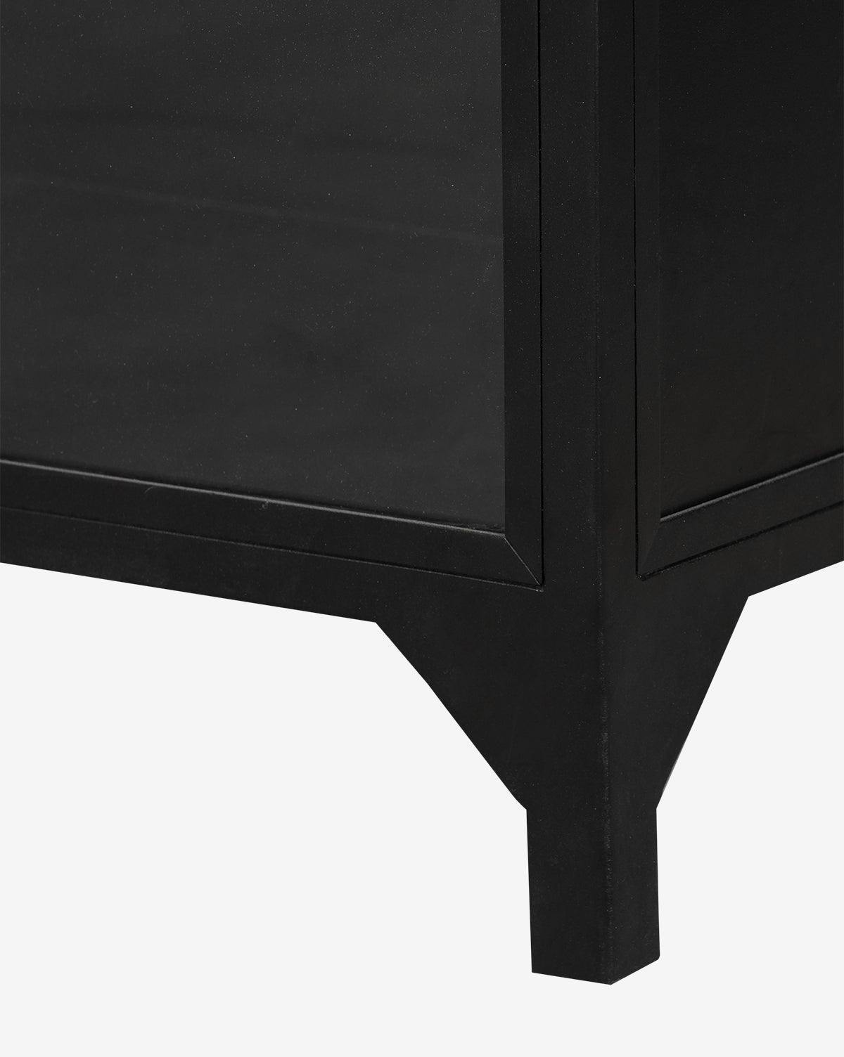 Close-up of the bottom corner of the Darcie Wide Cabinet, featuring a black iron frame with angled legs and a rectangular silhouette, set against a plain white background by McGee & Co.