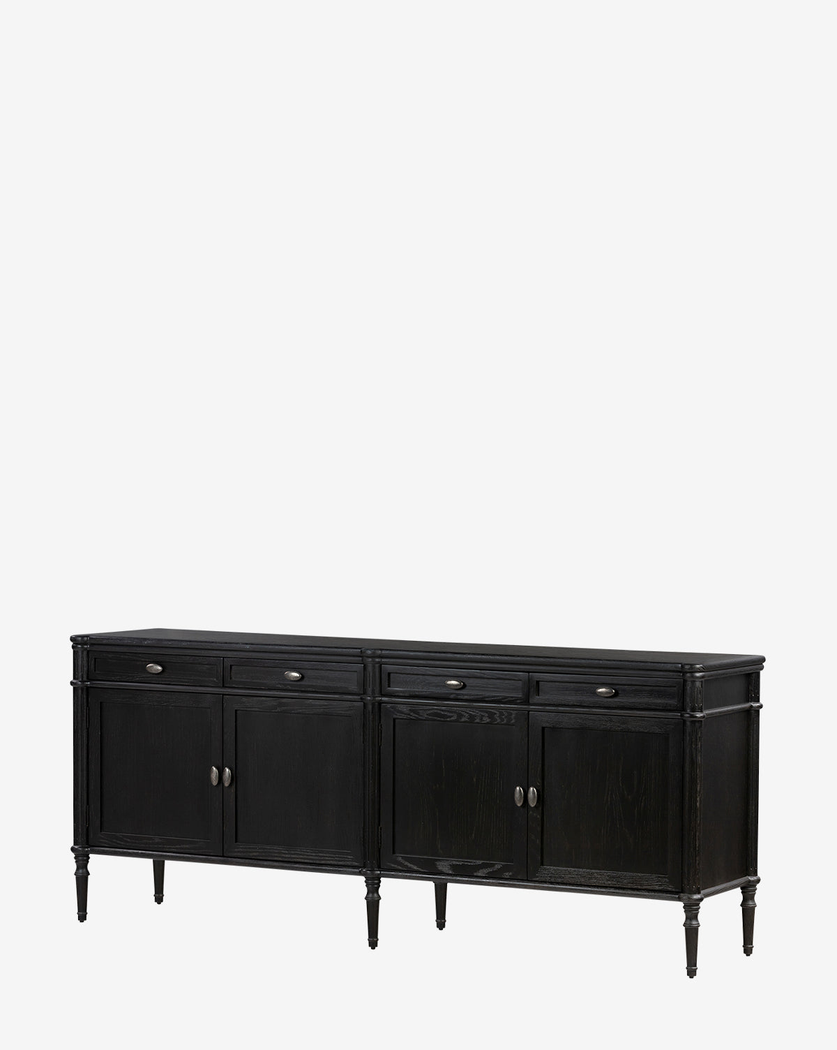 The Dixon Sideboard is a black oak piece with four drawers, four cabinet doors featuring aged brass hardware, and stands on six tapered legs for a classic, timeless look, by McGee & Co.