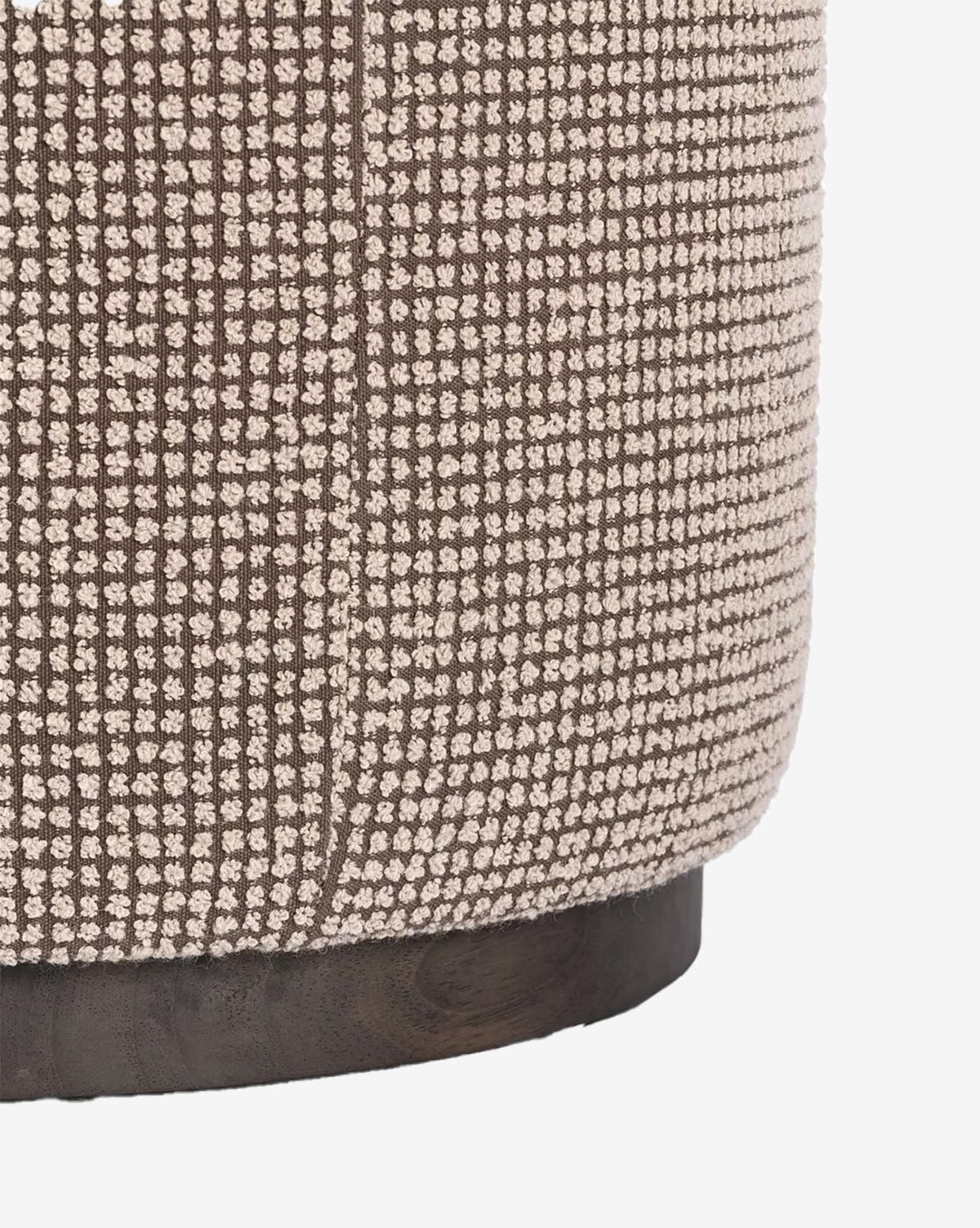 Close-up of the Dawson Ottoman, featuring a brown and cream checkered fabric cushion atop a sturdy wooden base, by McGee & Co.