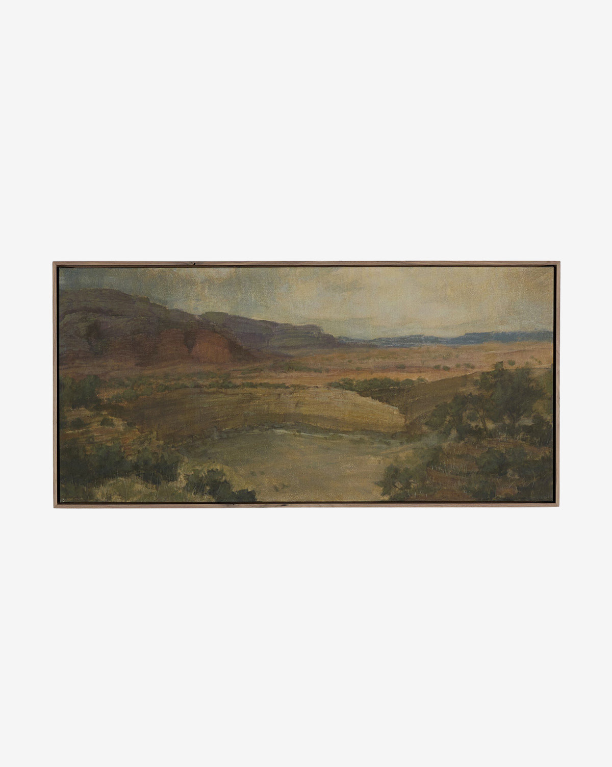 Desert Hues II by Aileen Fitzgerald is a framed art print featuring a wide, hazy landscape with distant hills, an open plain, river, and greenery beneath a muted sky—beautifully reproduced on fine art paper, by McGee & Co.