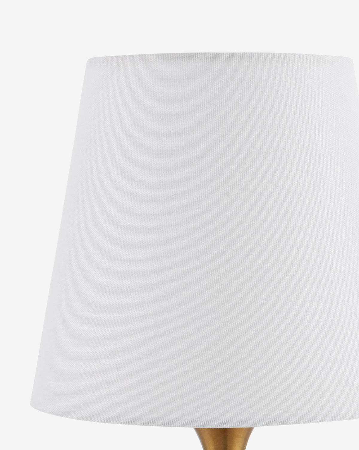 A close-up of the Diantha Table Lamps white fabric-textured lampshade on a plain white background, with the antique brass stem partially visible at the bottom, by McGee & Co.