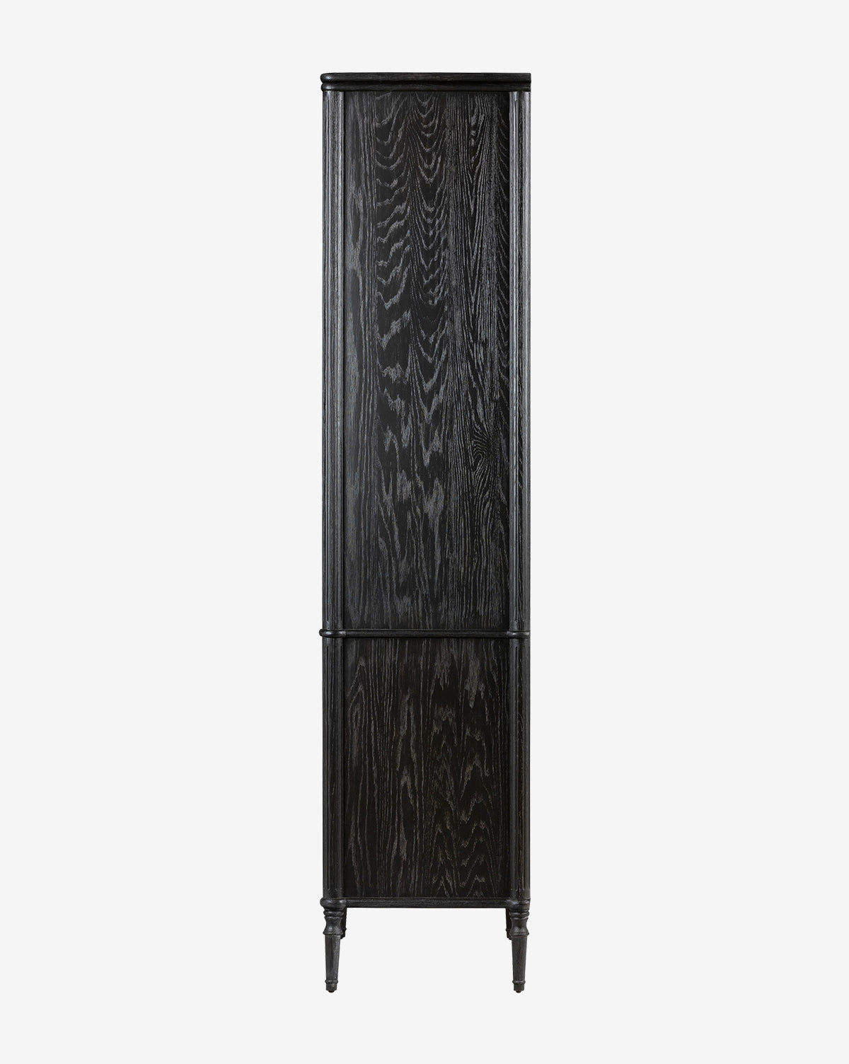 The Draven Cabinet features a tall, narrow design in distressed black wood with a subtle grain texture, two doors, and four slender legs, shown against a plain white background by McGee & Co.