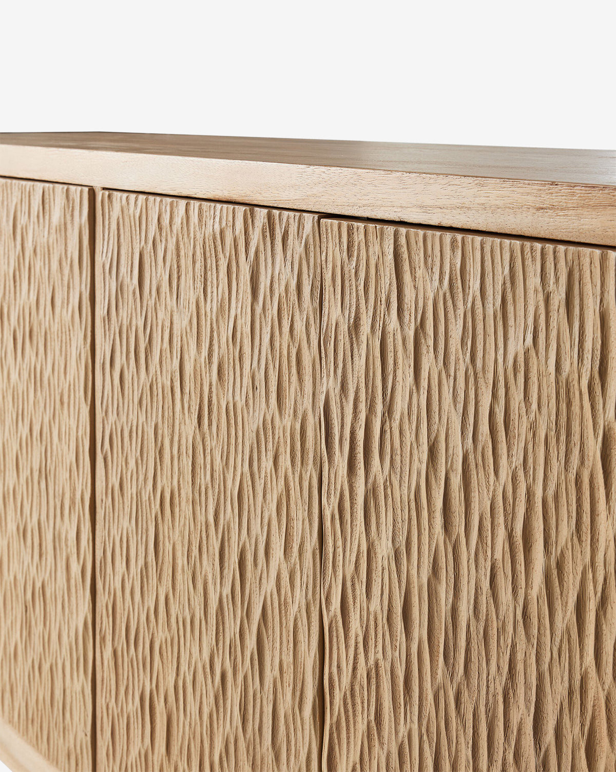 A close-up of the Drayton Sideboard, a light wood cabinet with wavy, carved door patterns. Its natural finish highlights the grain and intricate design—ideal as entryway furniture, by McGee & Co.