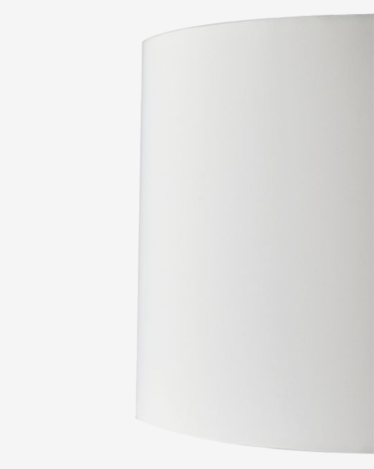 A close-up shows the right half of the Dynasty Table Lamp’s tapered off-white shade against a white background, by McGee & Co.