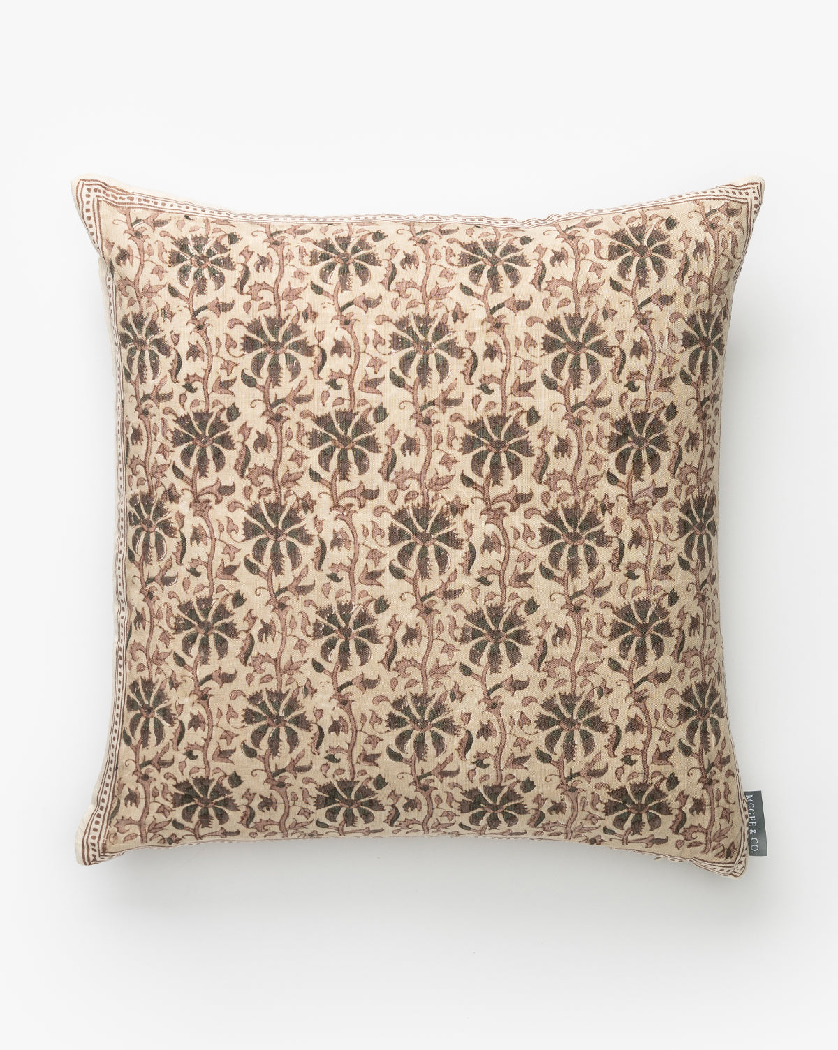 The Edith Pillow Cover showcases a beige background with an intricate brown floral and vine design, complemented by a thin geometric border and finished with a small fabric tag on one edge, by McGee & Co.