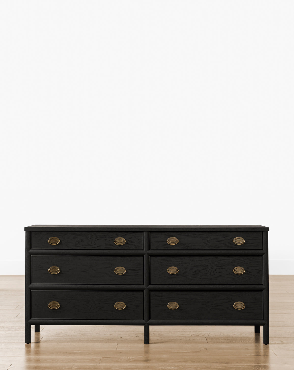The Edward Dresser, in Black Ash, provides stylish bedroom storage with six drawers and round brass handles, by McGee & Co. Shown on a light wood floor against a plain white background.