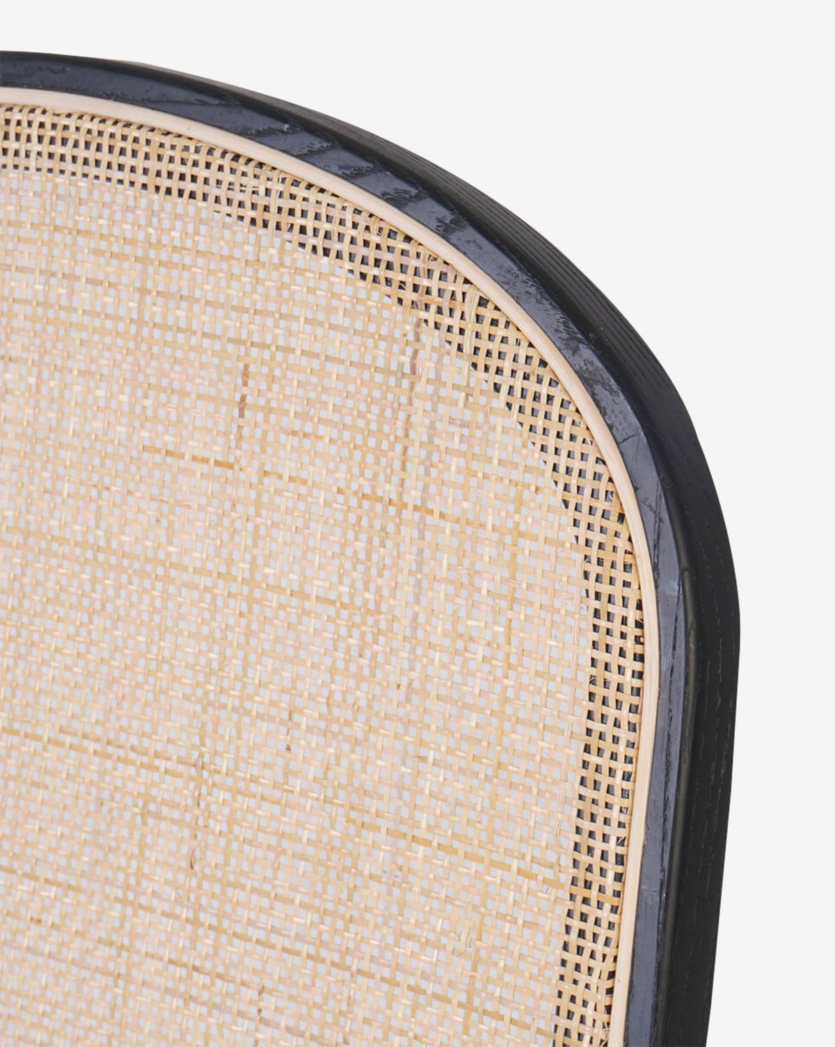Close-up of the Eira Dining Chairs curved back, featuring light woven cane framed by dark polished wood, by McGee & Co.