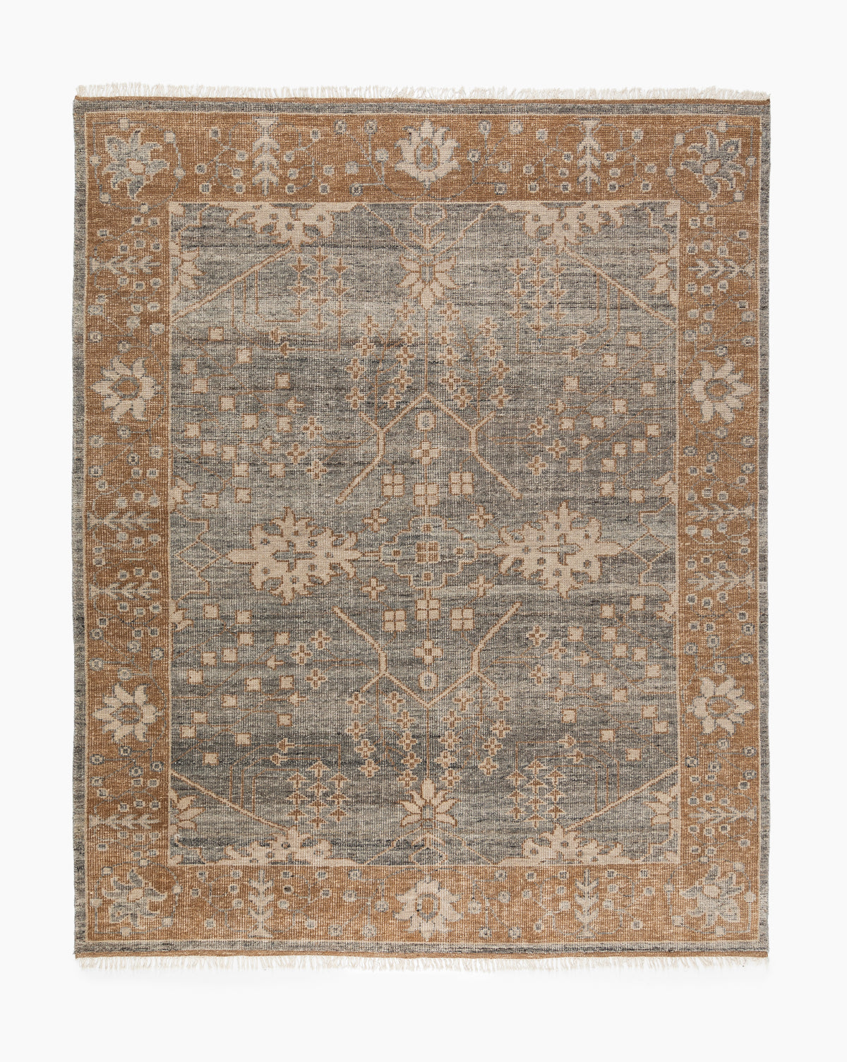 The Elison Hand-Knotted Wool Rug showcases a rectangular design with a central grey field, cream and tan floral patterns, a wide tan border with cream motifs, and short fringe at the edges for artisan detail, by McGee & Co.