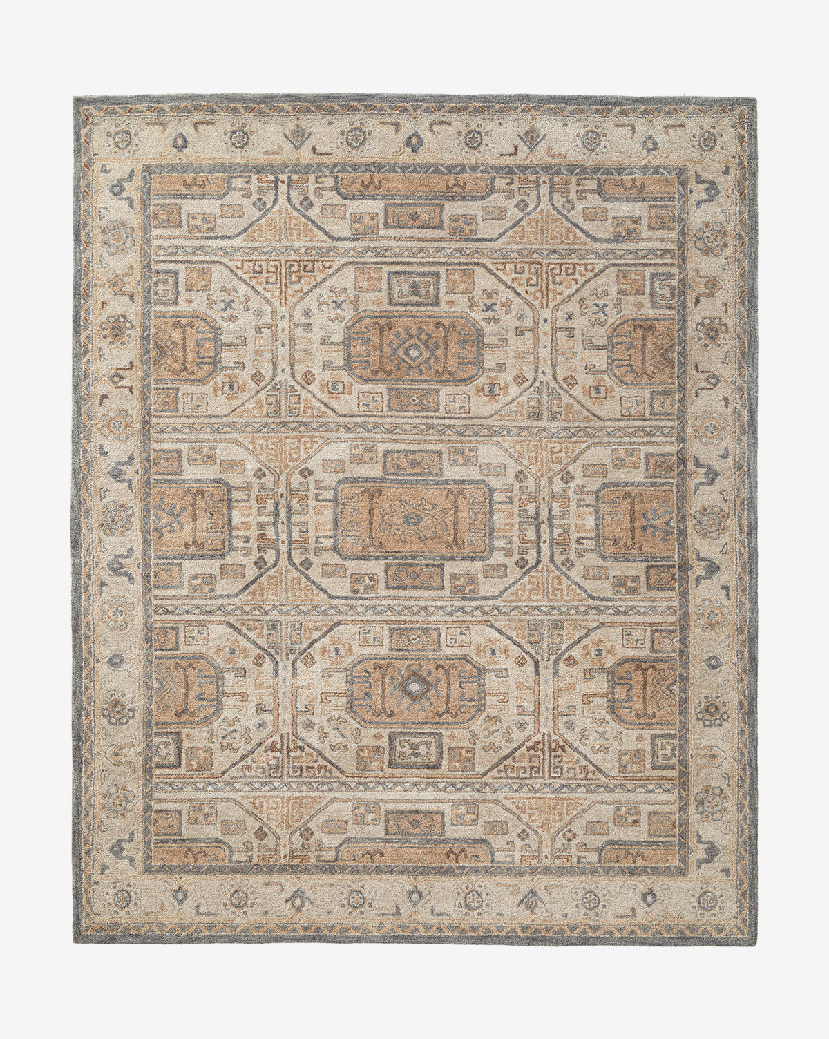 The Ellington Blue Hand-Tufted Wool Rug is a rectangular area rug featuring intricate geometric and floral patterns in soft blue tones, a decorative border, and symmetrical, repeating designs throughout by McGee & Co.