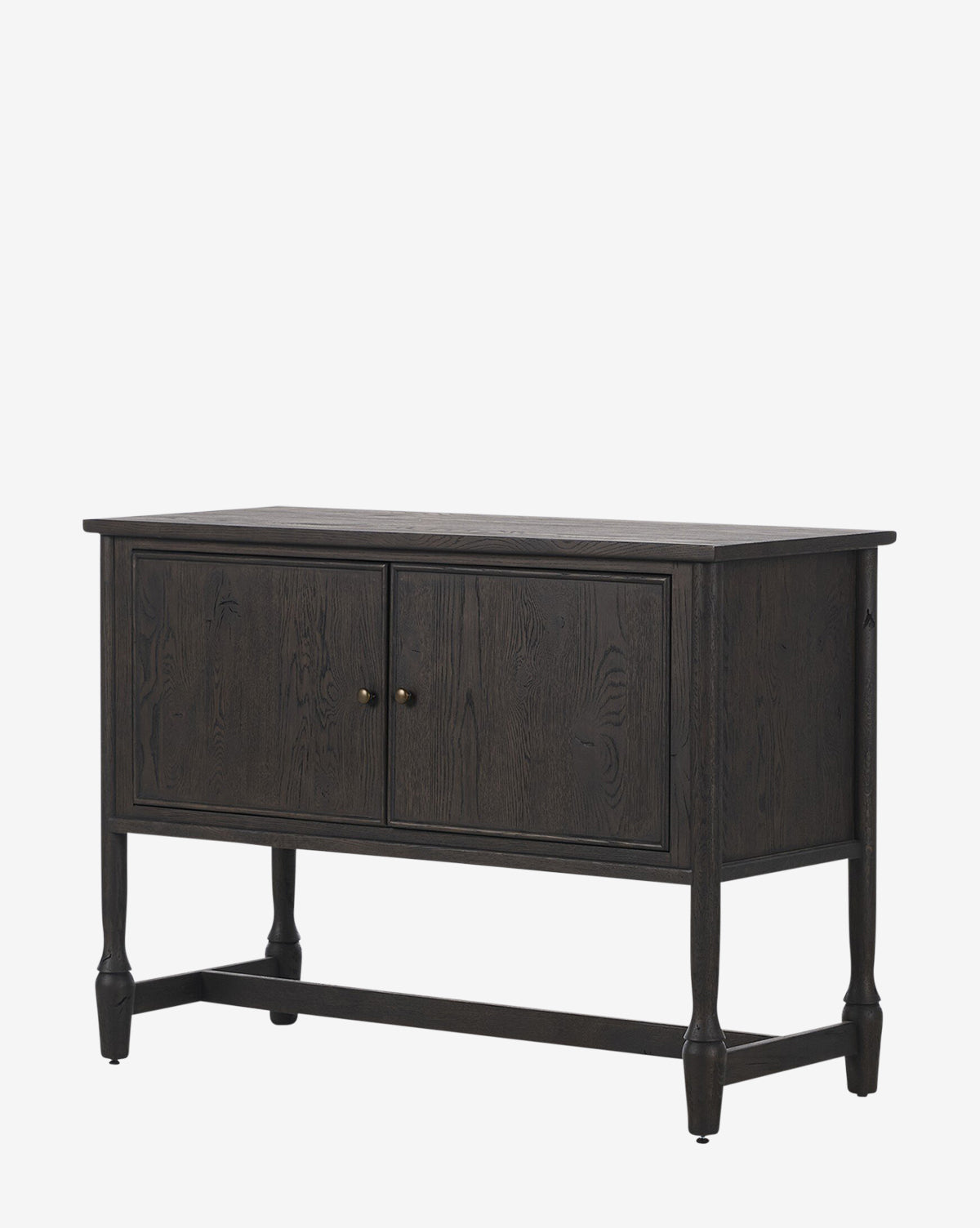 The Elmer Sideboard has a modern, classic design with a dark wood finish, cracked smoked black veneer, two front doors with small round handles, and four legs joined by a stretcher. Its smooth rectangular top completes the look, by McGee & Co.