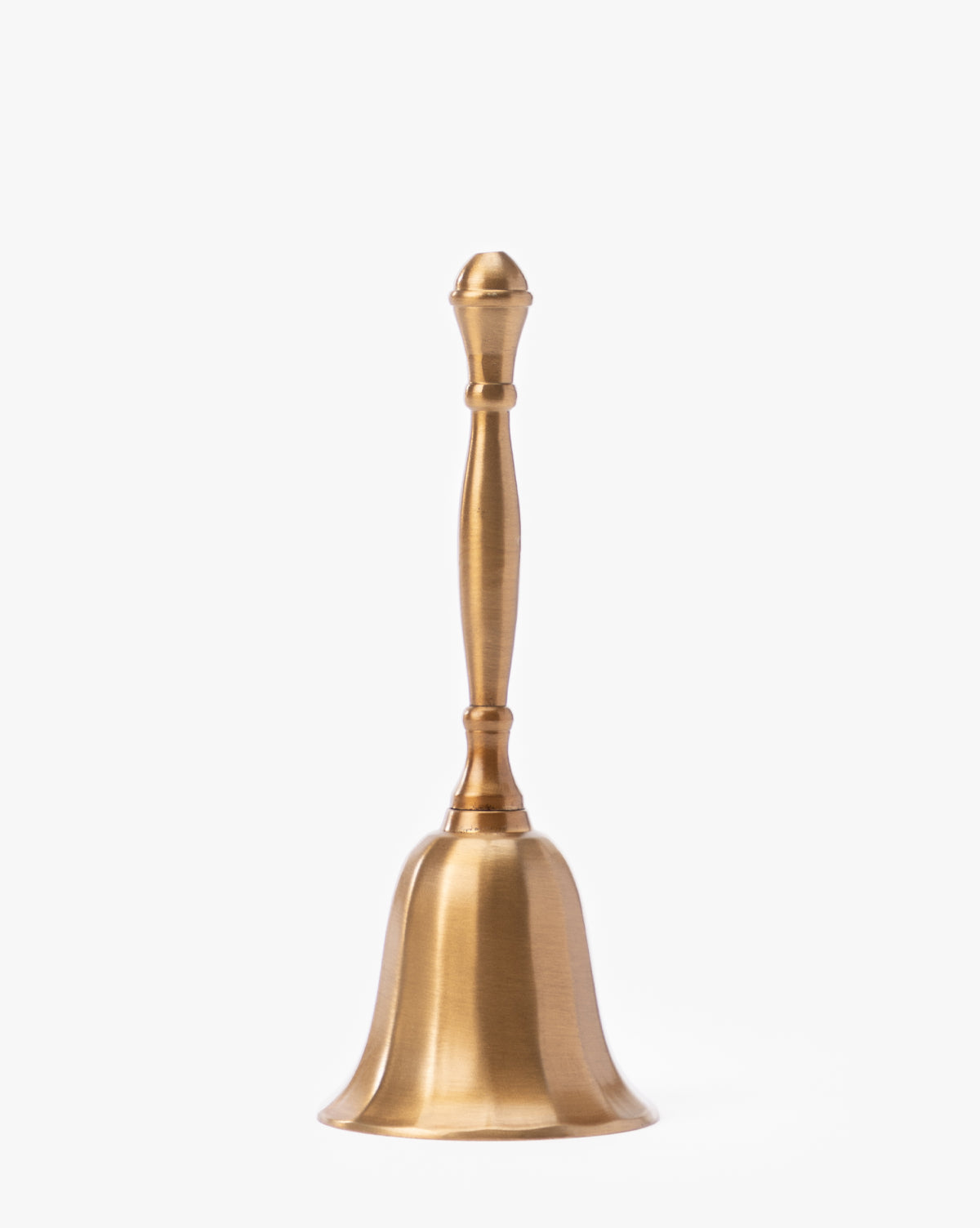 The Elsher Bell, featuring a smooth polished brass finish and a long, slender handle, stands upright against a white background—ideal as vintage or antique brass decor for any space, by McGee & Co.