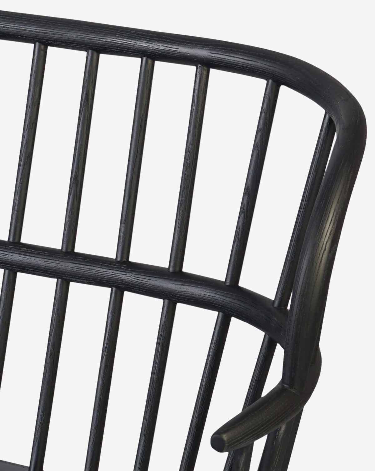 Close-up of the Elysia Bench’s black wooden backrest and armrest, featuring vertical slats, a curved design, and a solid ash frame, by McGee & Co.