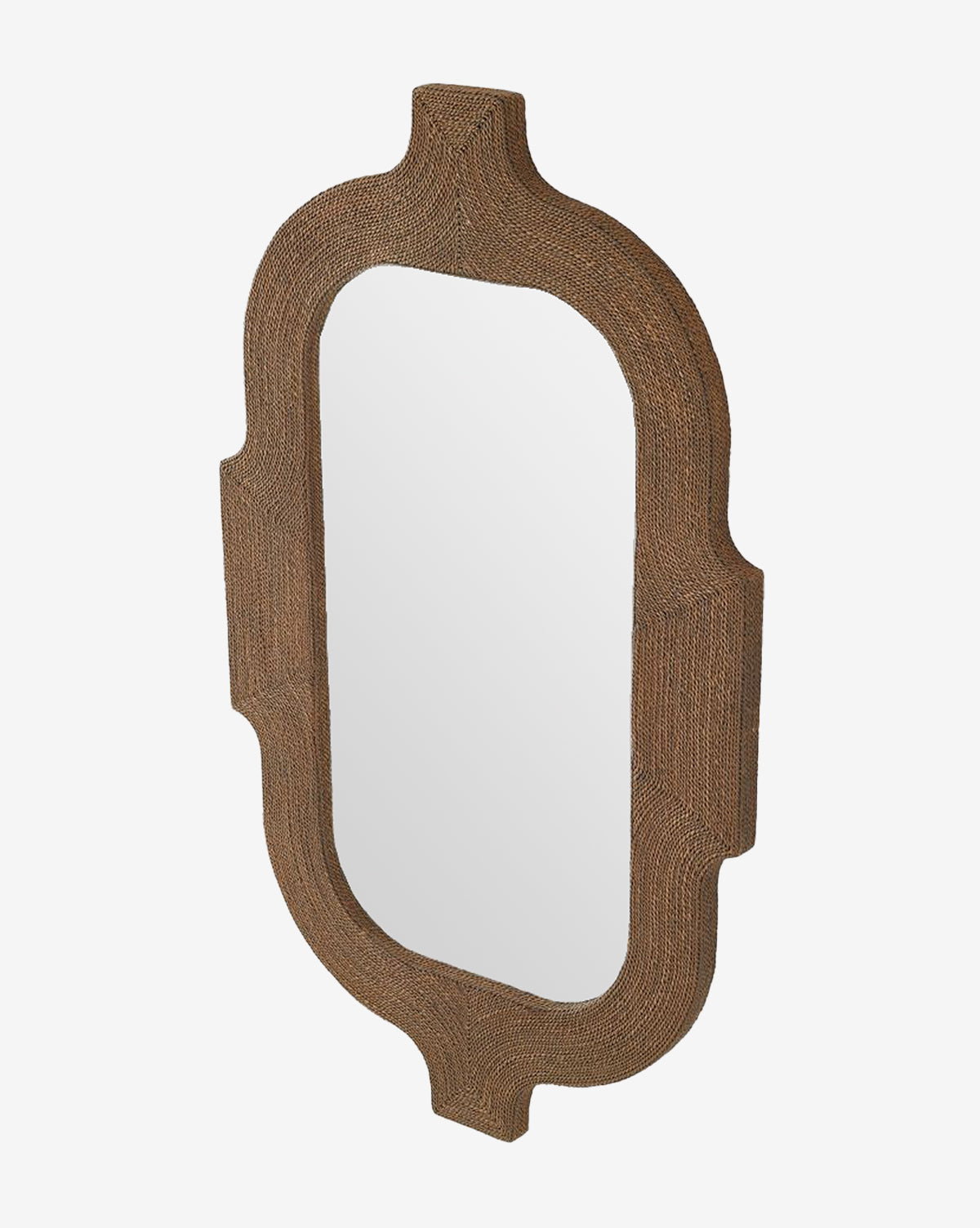 The Elysia Mirror features an ornate, textured brown frame inspired by Indian architecture with curved edges and a unique elongated shape. Shown here at an angle, its a decorative piece for any space by McGee & Co.