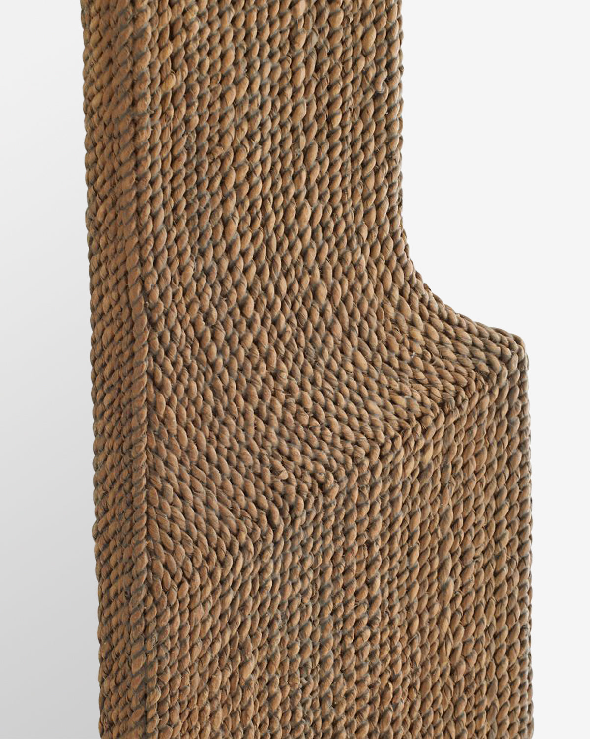 Close-up of the Elysia Mirror, showcasing its woven seagrass frame with curved and angular edges, detailed with abaca rope that enhances its textured, natural brown design against a plain white background by McGee & Co.