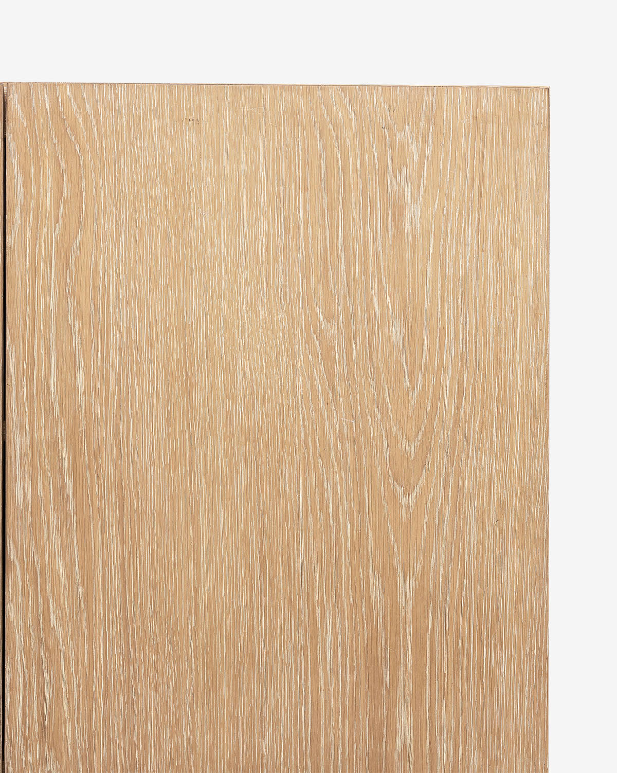 A close-up of the Emilee Sideboard’s light wooden surface with a matte finish, showcasing its natural grain, subtle lines, and knots in beige and tan tones against a white background, by McGee & Co.