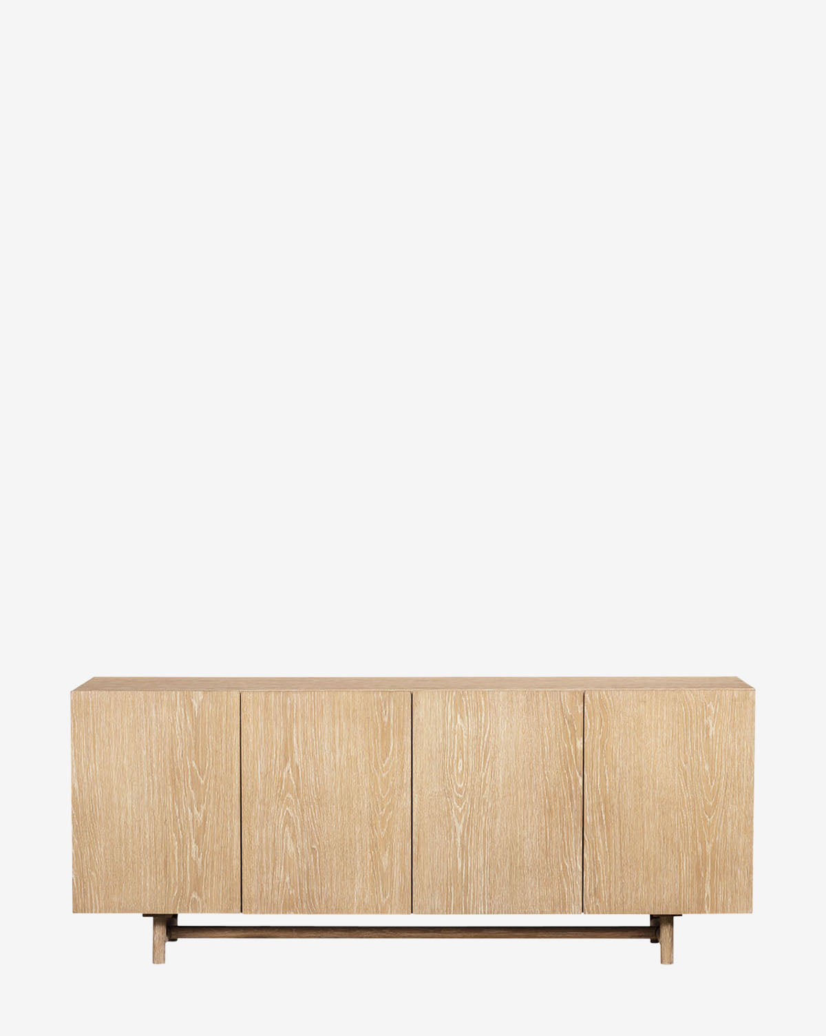 The Emilee Sideboard is a minimalist modern rustic piece in light, whitewashed oak with four cabinet doors, a simple base, and a smooth matte finish, shown against a plain white background by McGee & Co.