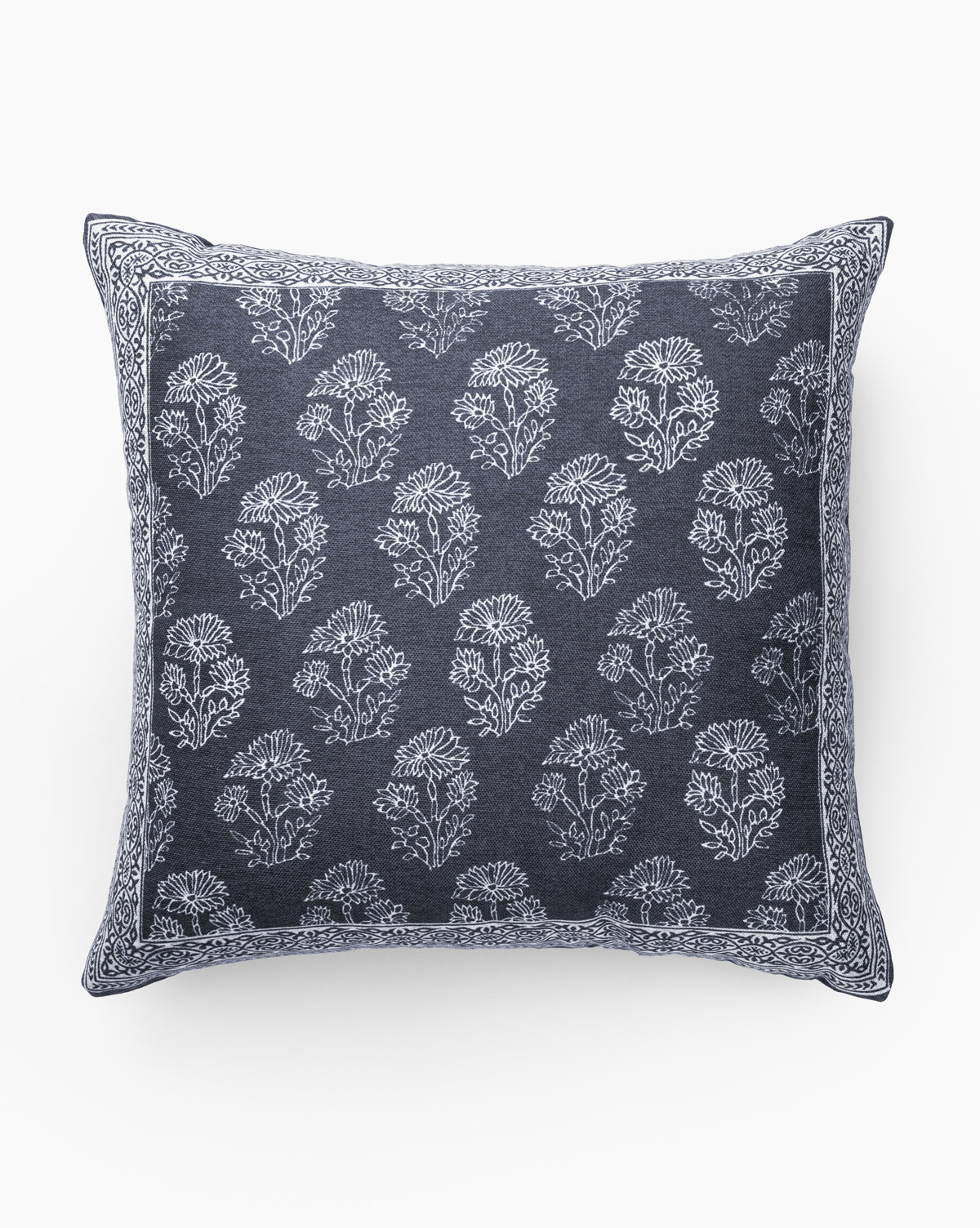 The Emmy Indoor/Outdoor Pillow features a square dark blue design with a white floral pattern and ornate white border. Weather-resistant, it’s ideal for both indoor and outdoor use and is shown against a plain white background by McGee & Co.