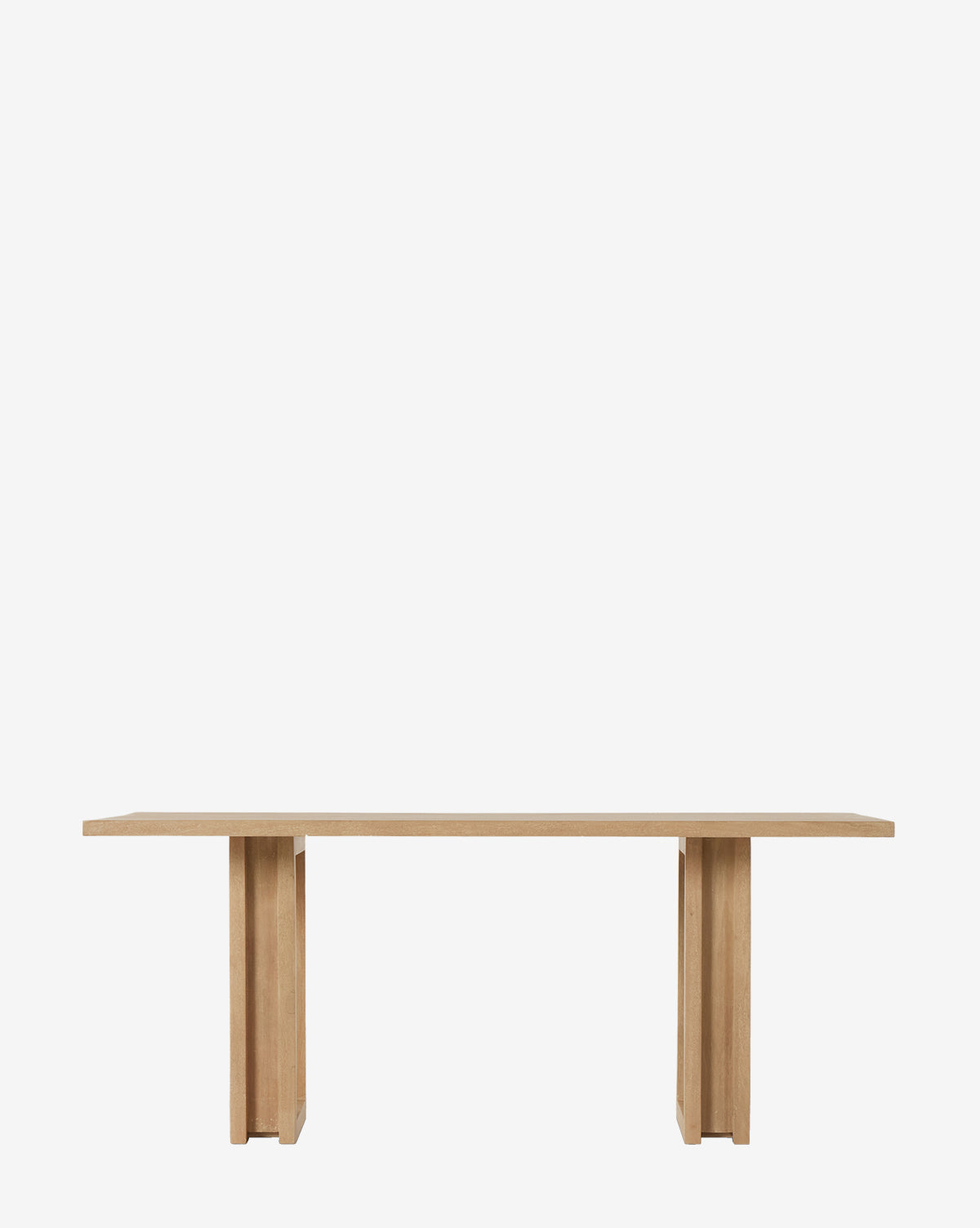 The Ernie Dining Table is a modern rectangular table made from solid mango wood, with two wide pedestal legs and a flat tabletop—ideal for any contemporary dining room, by McGee & Co.