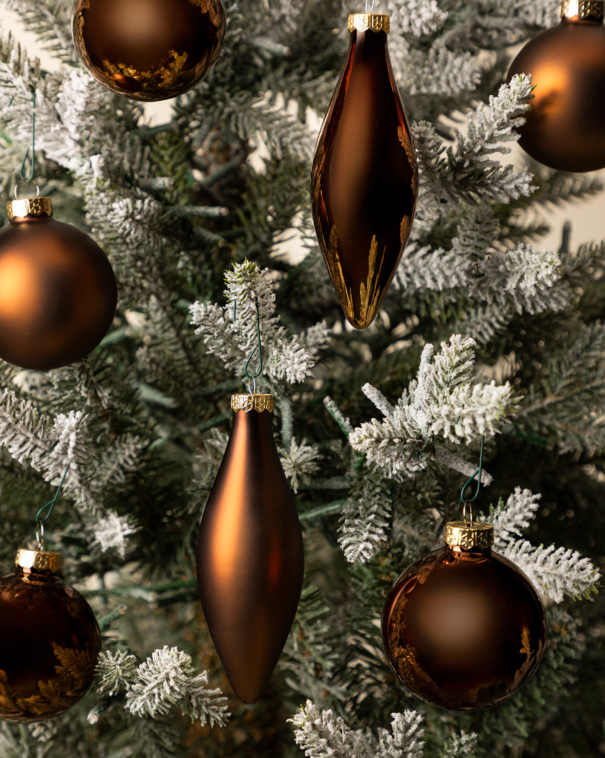 Snow-dusted branches lend modern sophistication to the festive décor, by McGee & Co.