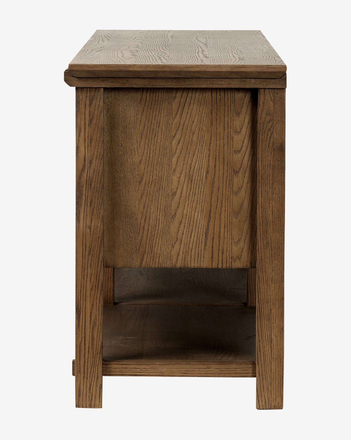 The Evaline Sideboard features solid oak, a rectangular form, visible wood grain, and a lower shelf, shown from the narrow side against a white background by McGee & Co.