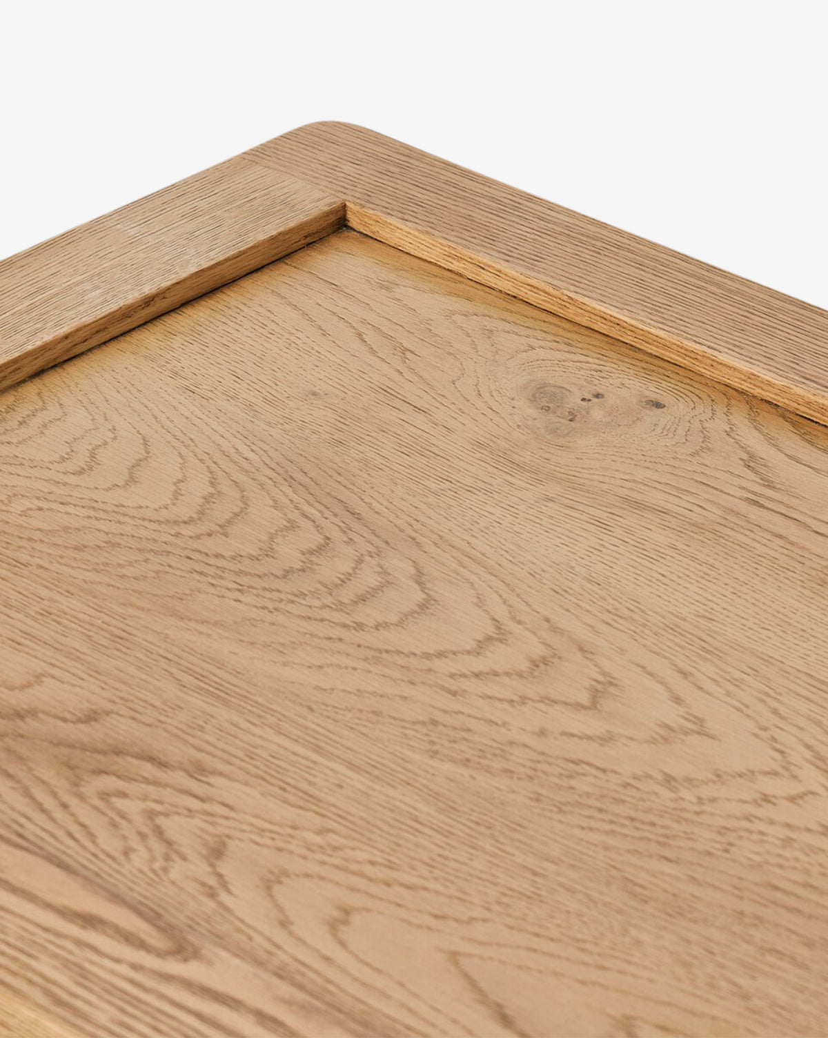 Close-up of a light oak veneer tray with visible wood grain and raised edge, set against a white background—an ideal accent for bedroom decor on your Faelan Nightstand, by McGee & Co.