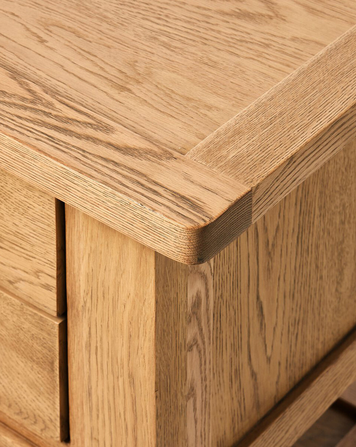 Close-up of the Faelan Nightstand in light oak veneer highlighting its natural grain and precise joinery. The smooth, refined finish makes it ideal for elevating bedroom style, by McGee & Co.